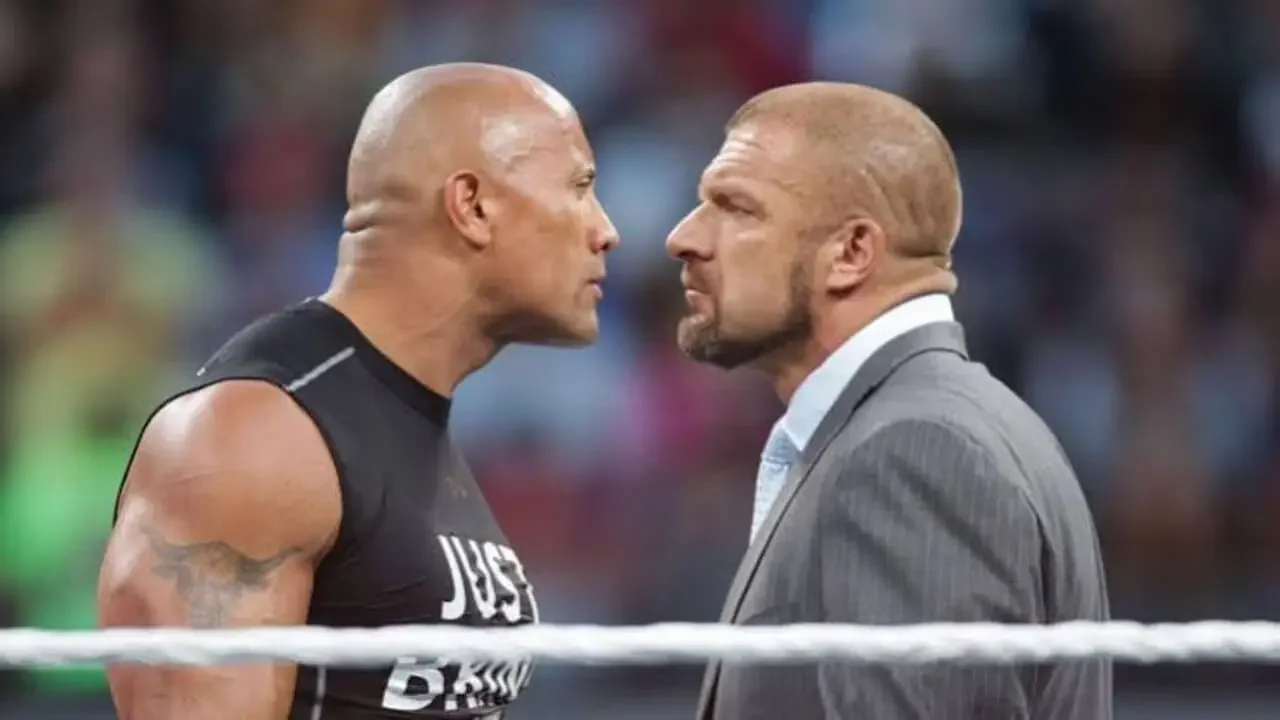 The Rock and Triple H face-to-face in a tense confrontation inside a WWE wrestling ring.