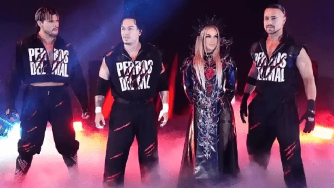 Los Perros Del Mal stable members Daga, Berto, and Angel standing alongside Karmen Petrovic in matching black ring gear amid stage smoke and red lighting.