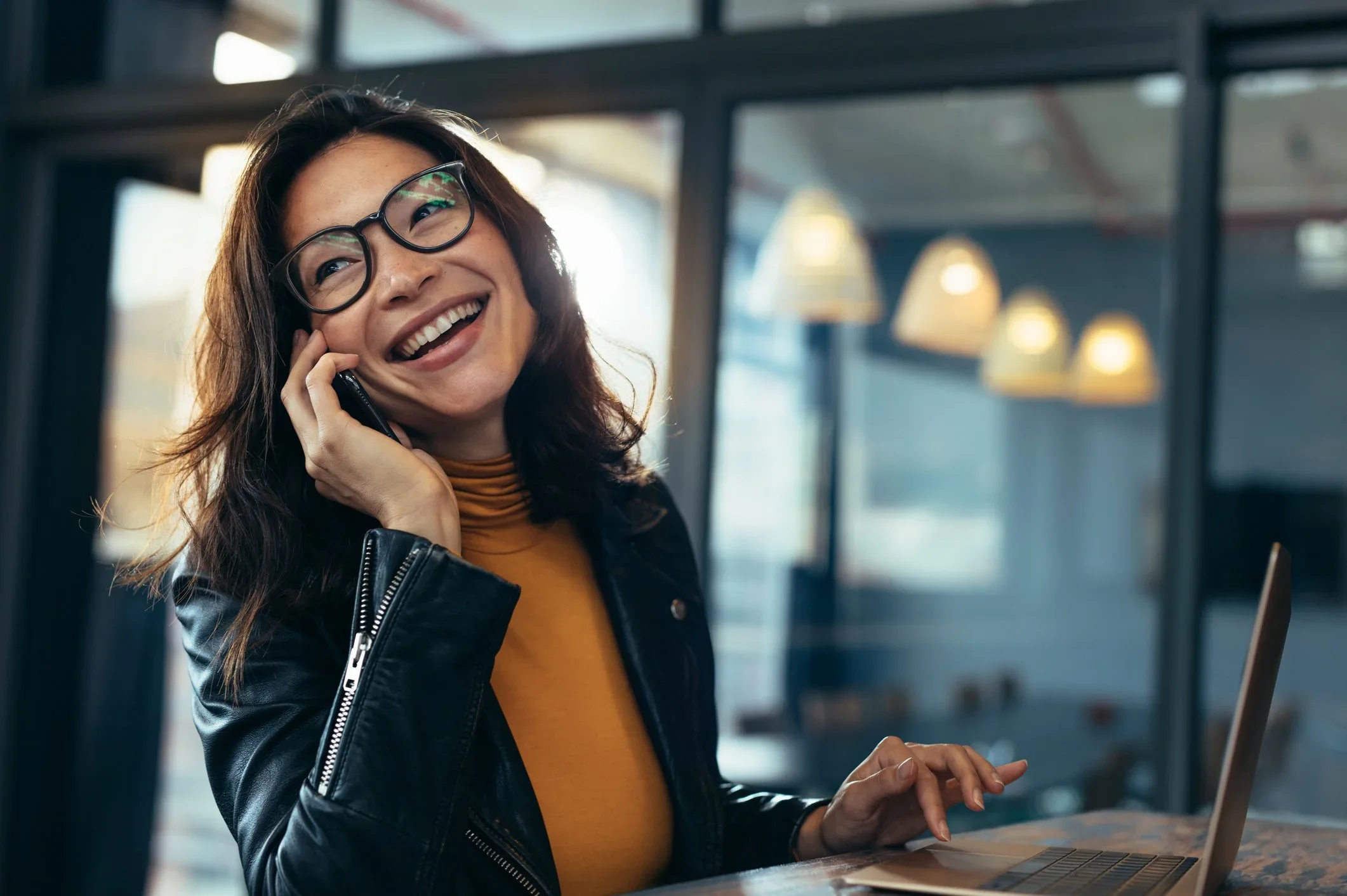 Woman on phone smiling.