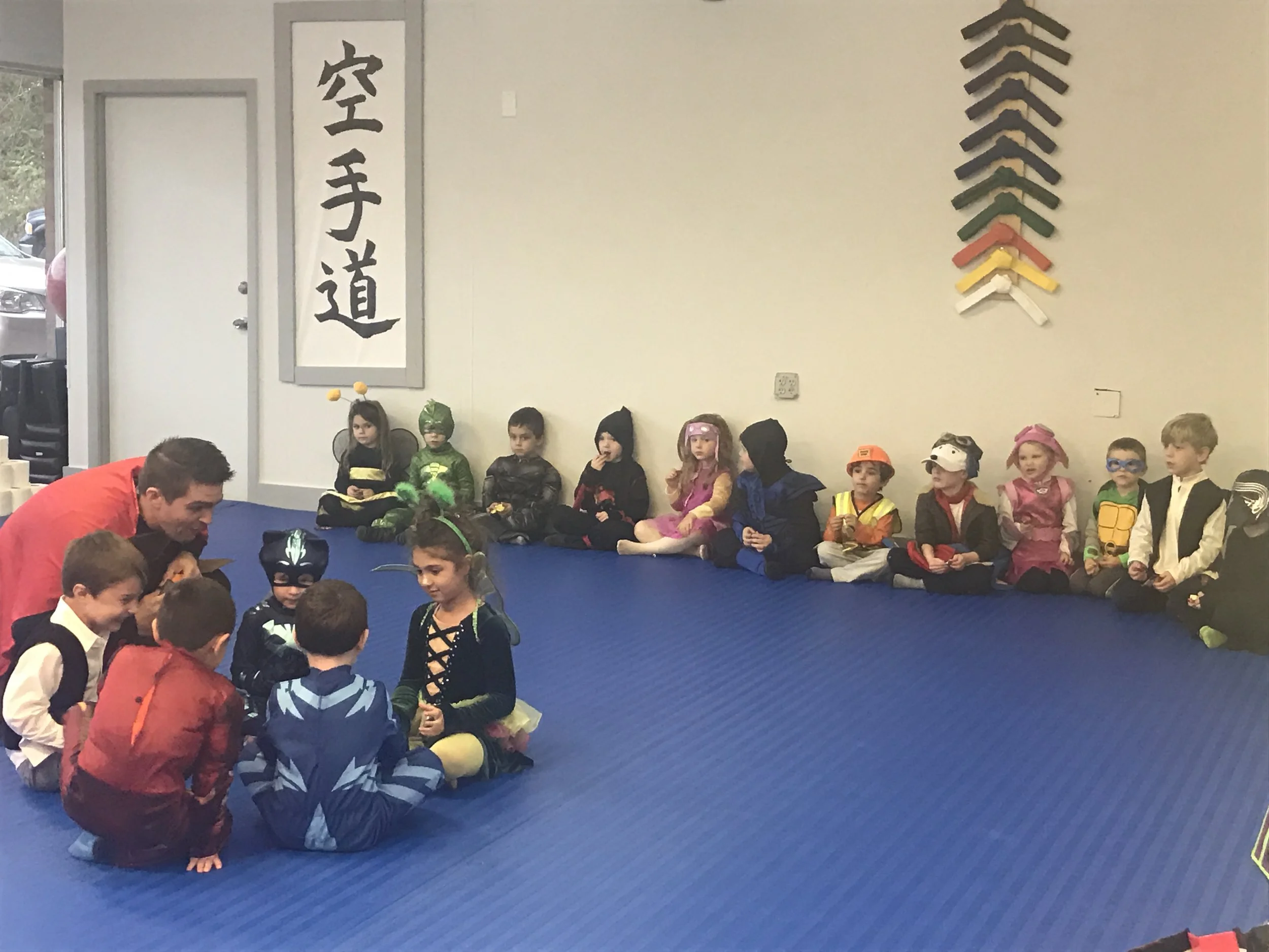 passing the pumpkin as their classmates watch!