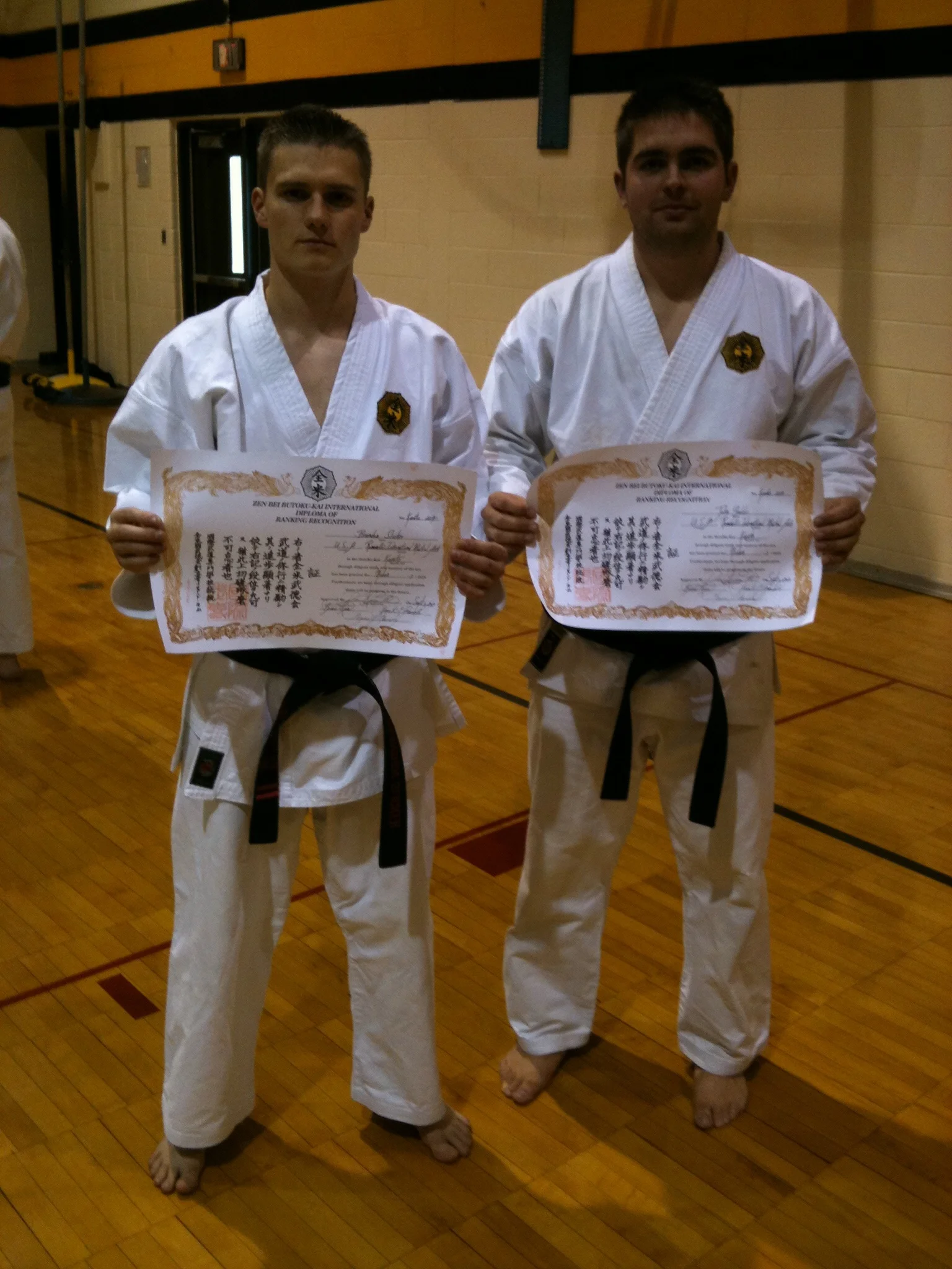  Sensei Brandon Slicker of Detroit MI and Sensei Gaddis of Pittsburgh PA hold up their Nidan certificates after receiving them 