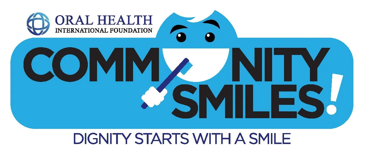 Logo for Oral Health International Foundation featuring a stylized face with a toothbrush in the mouth, surrounded by the words "COMMUNITY SMILES!" and the slogan "DIGNITY STARTS WITH A SMILE".