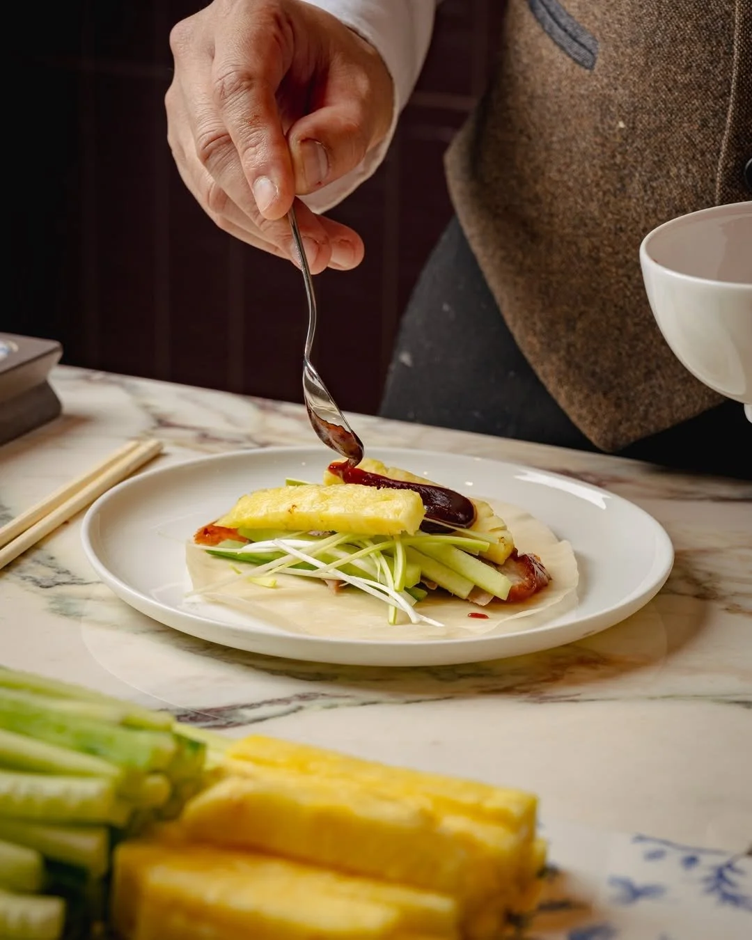 luxury chinese pork and noodles being picked up with chopsticks