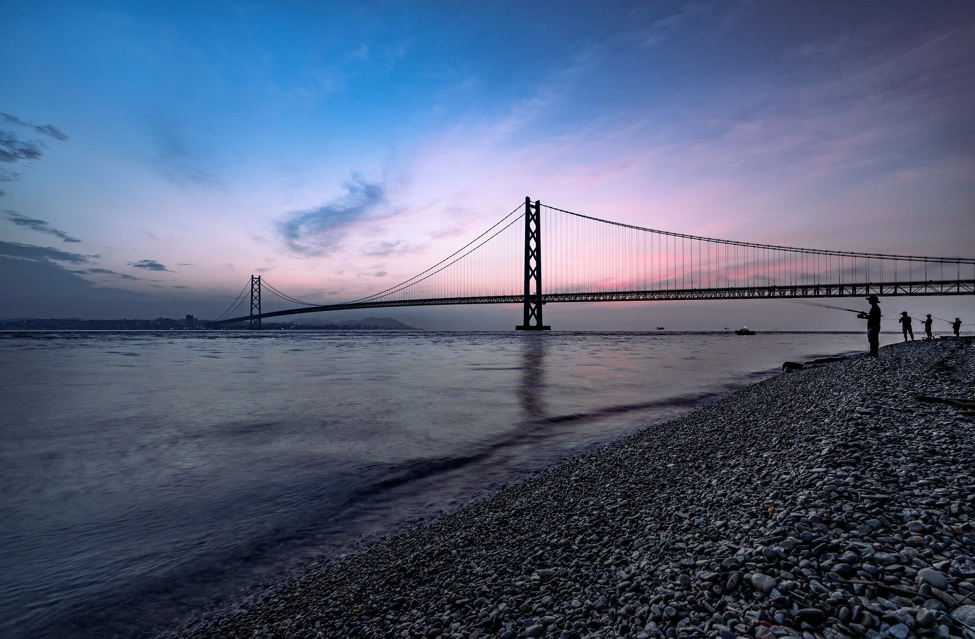 Close-up of a person holding another person's hand, with both wearing hospital gowns.