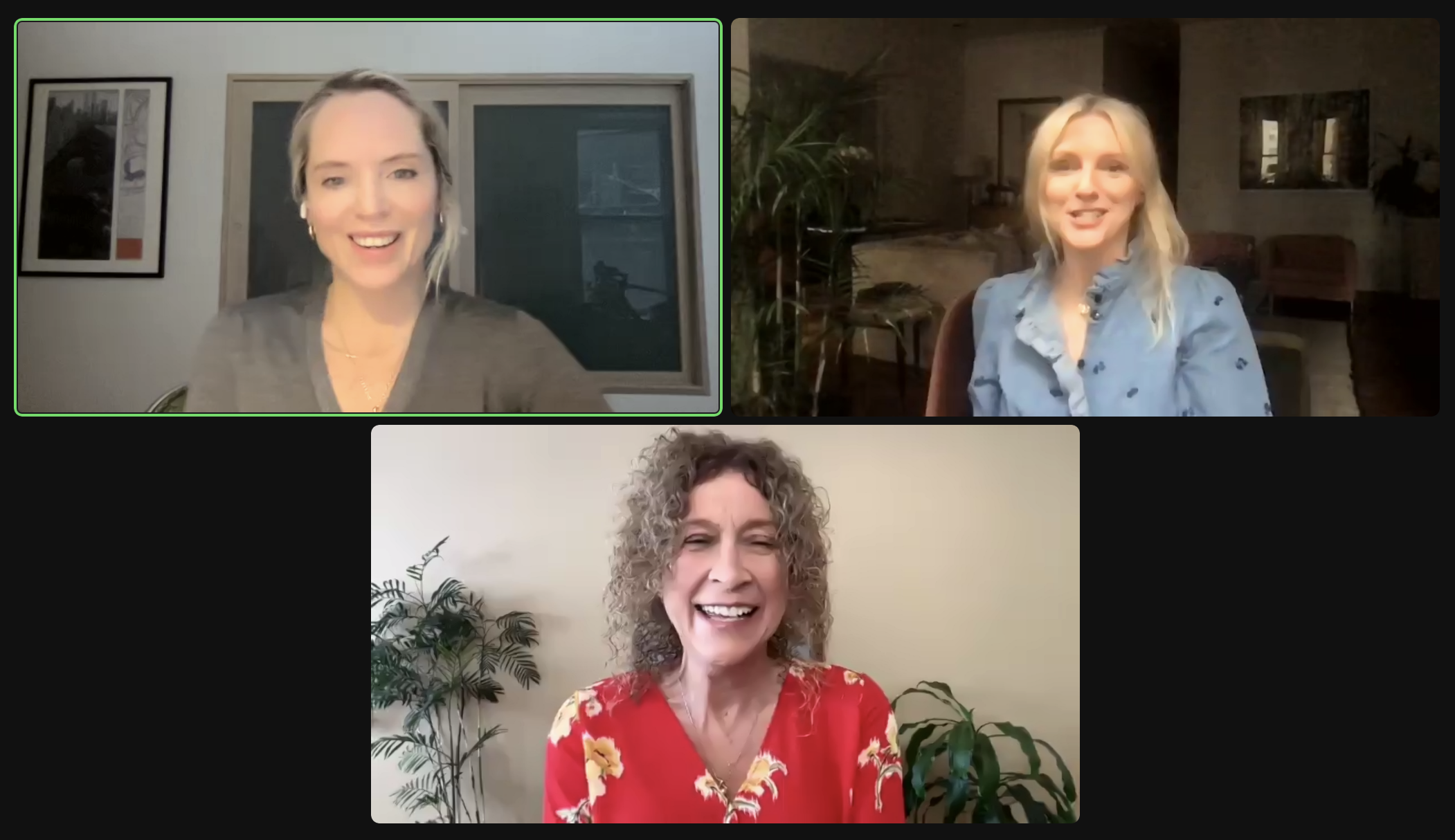 Three women participating in a virtual meeting, each in their own home environment, smiling and engaging with the camera.