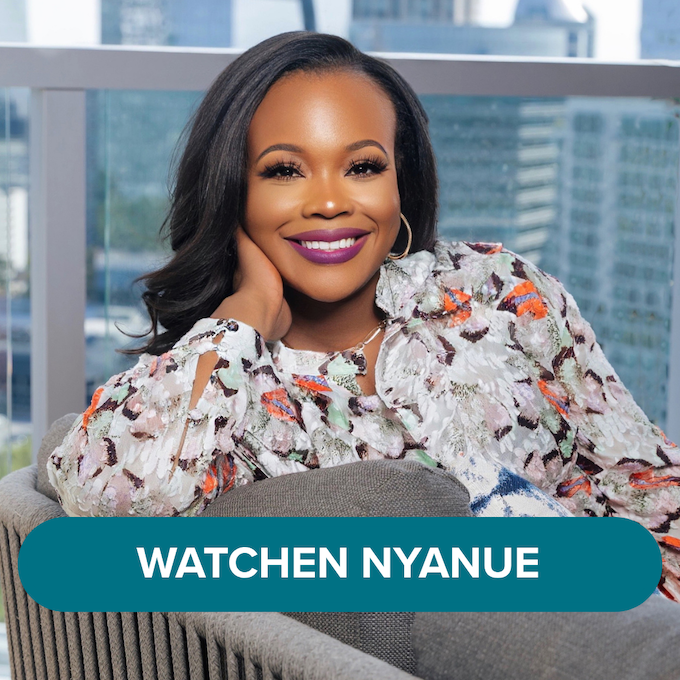 A woman with dark hair and purple lipstick smiling, sitting on a gray sofa in a high-rise office with a city view, wearing a multicolored floral blouse. There is text overlay that says, 'WATCHEN NYANUE'.