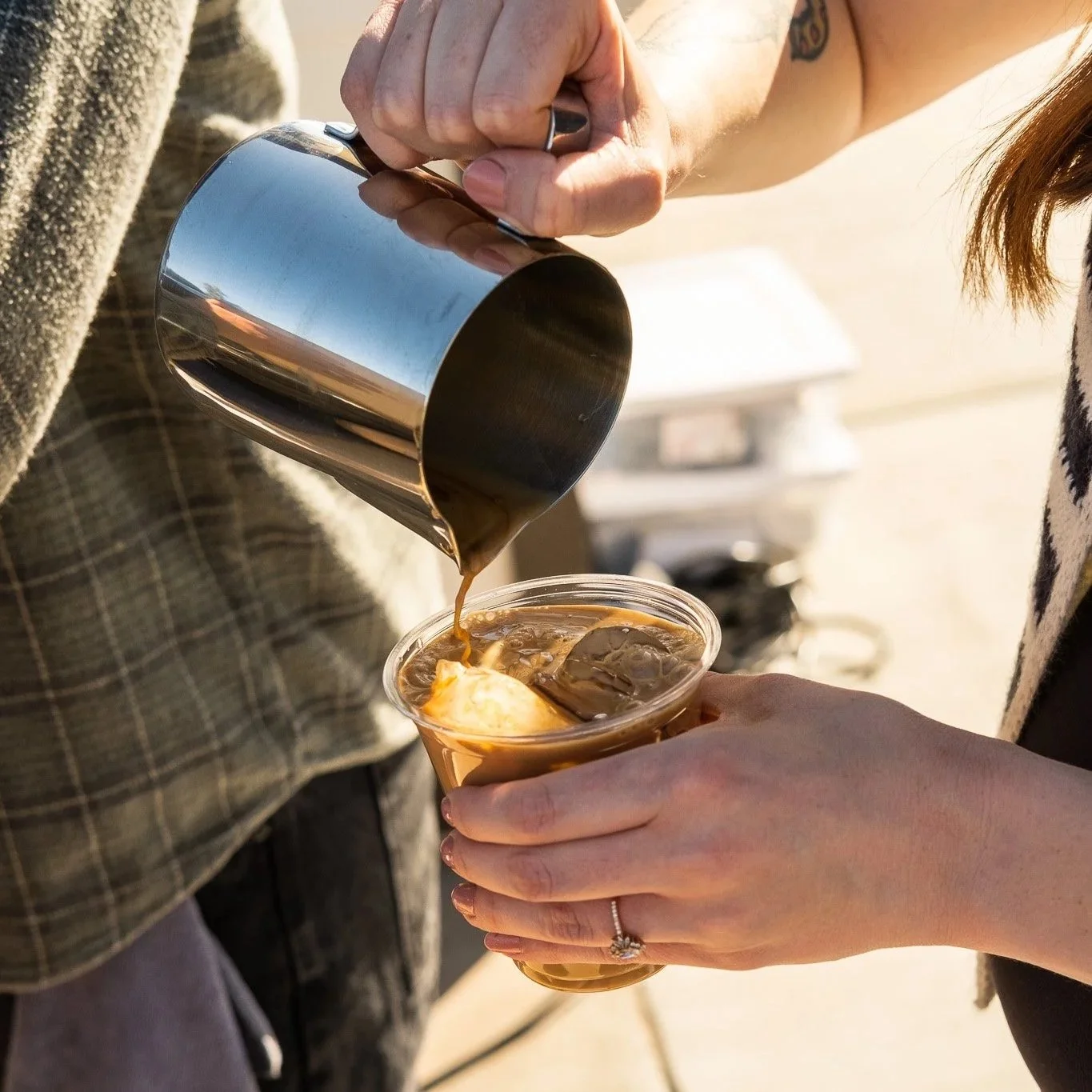 Barista serving latte to customer at a private event in Phoenix, Arizona.