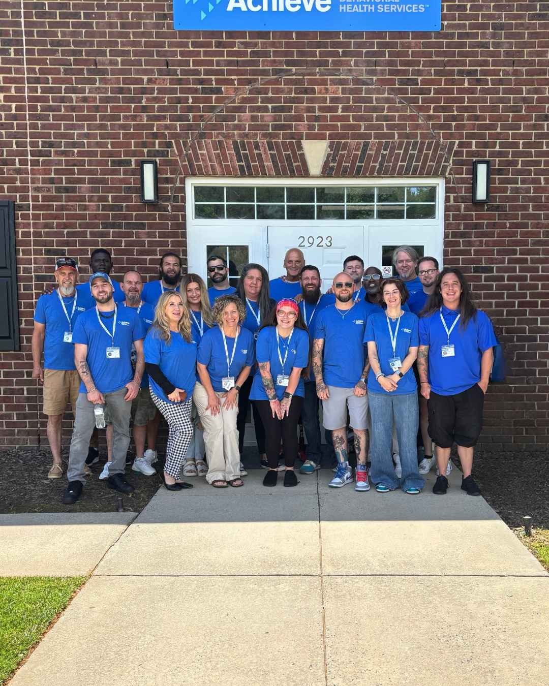 North Carolina location staff, all wearing matching blue shirts and identification badges.