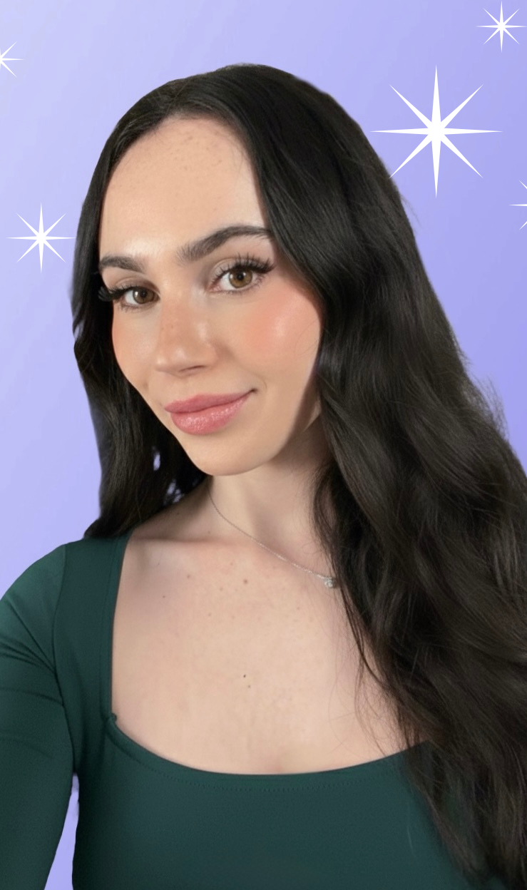 A woman with long dark hair, wearing a green top, smiling at the camera against a purple background with star illustrations.