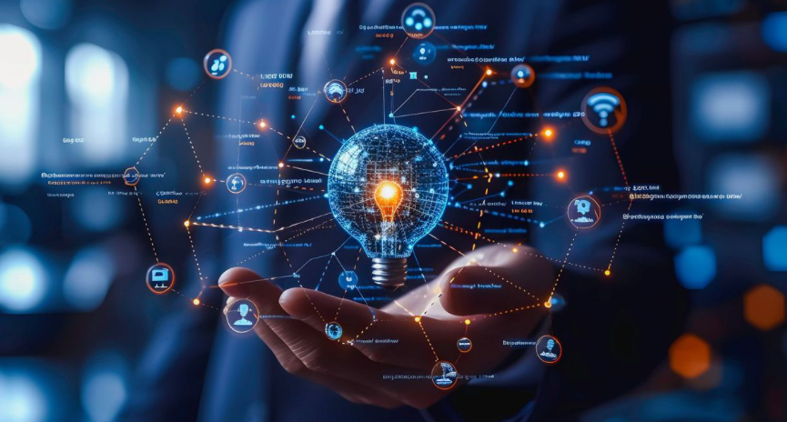 A hand holding a digital illustration of a glowing light bulb surrounded by interconnected icons representing technology and innovation.