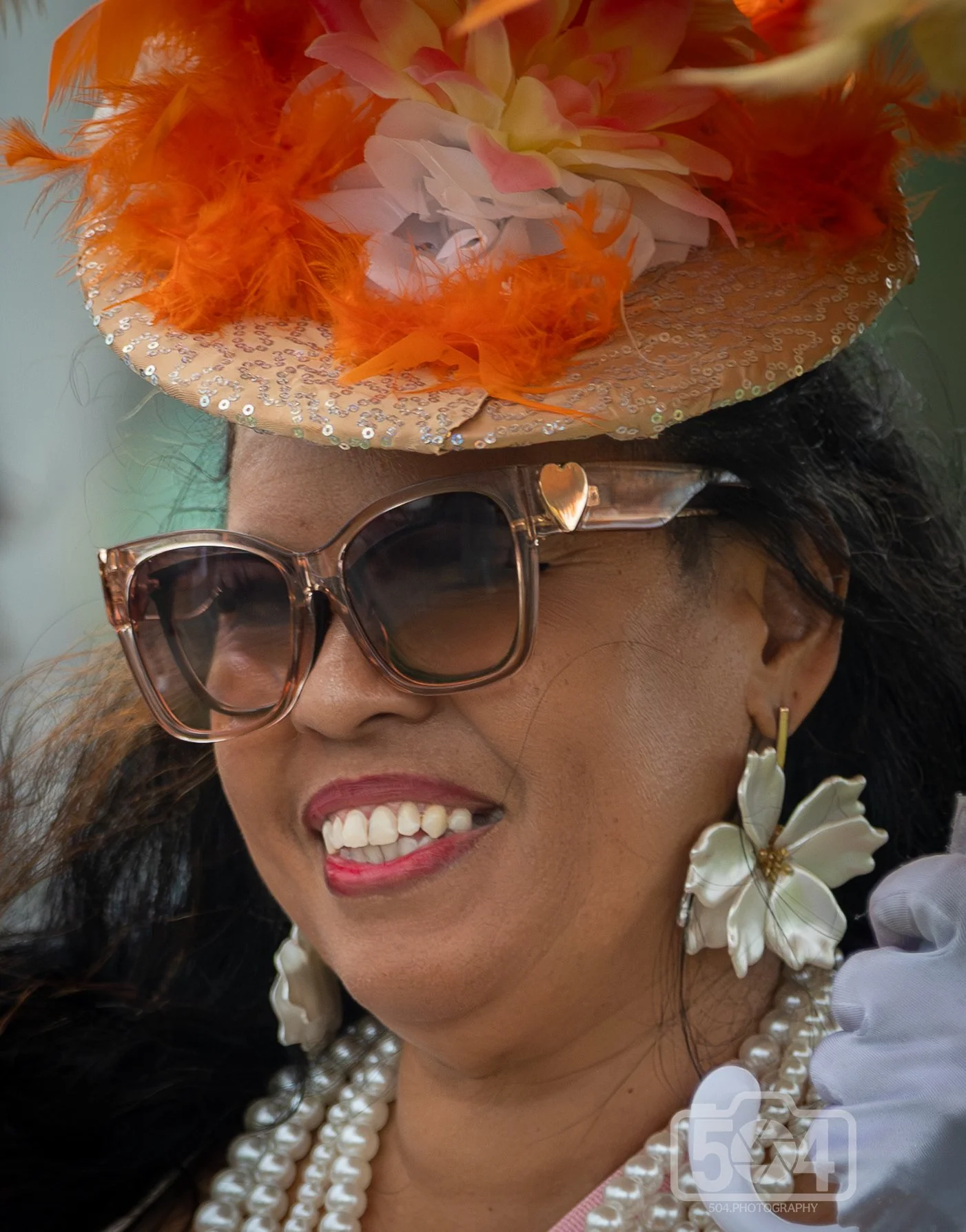 lady with two pairs of glasses and orange flowers in hat.jpg