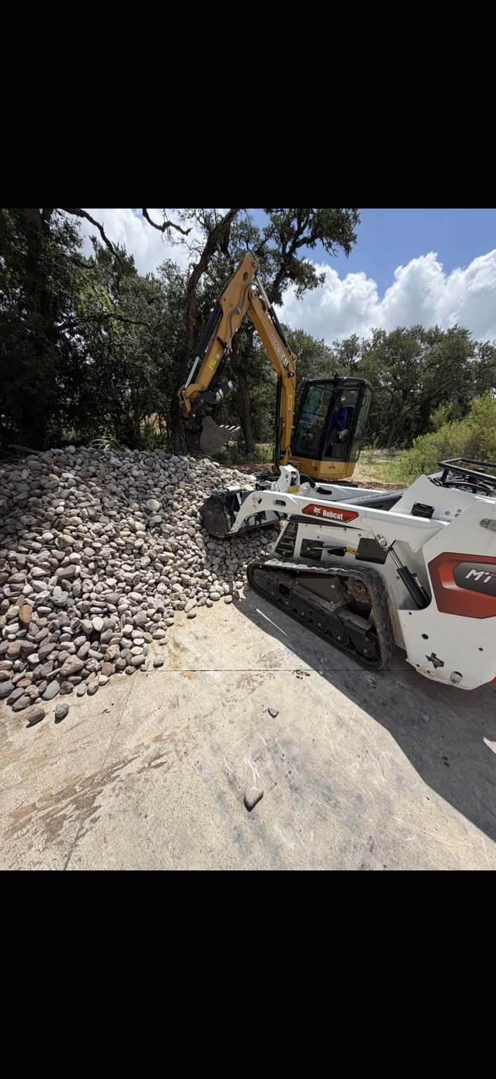 A2 Plumbing Cat 304 excavator and Bobcat MT100 performing utility work in San Antonio