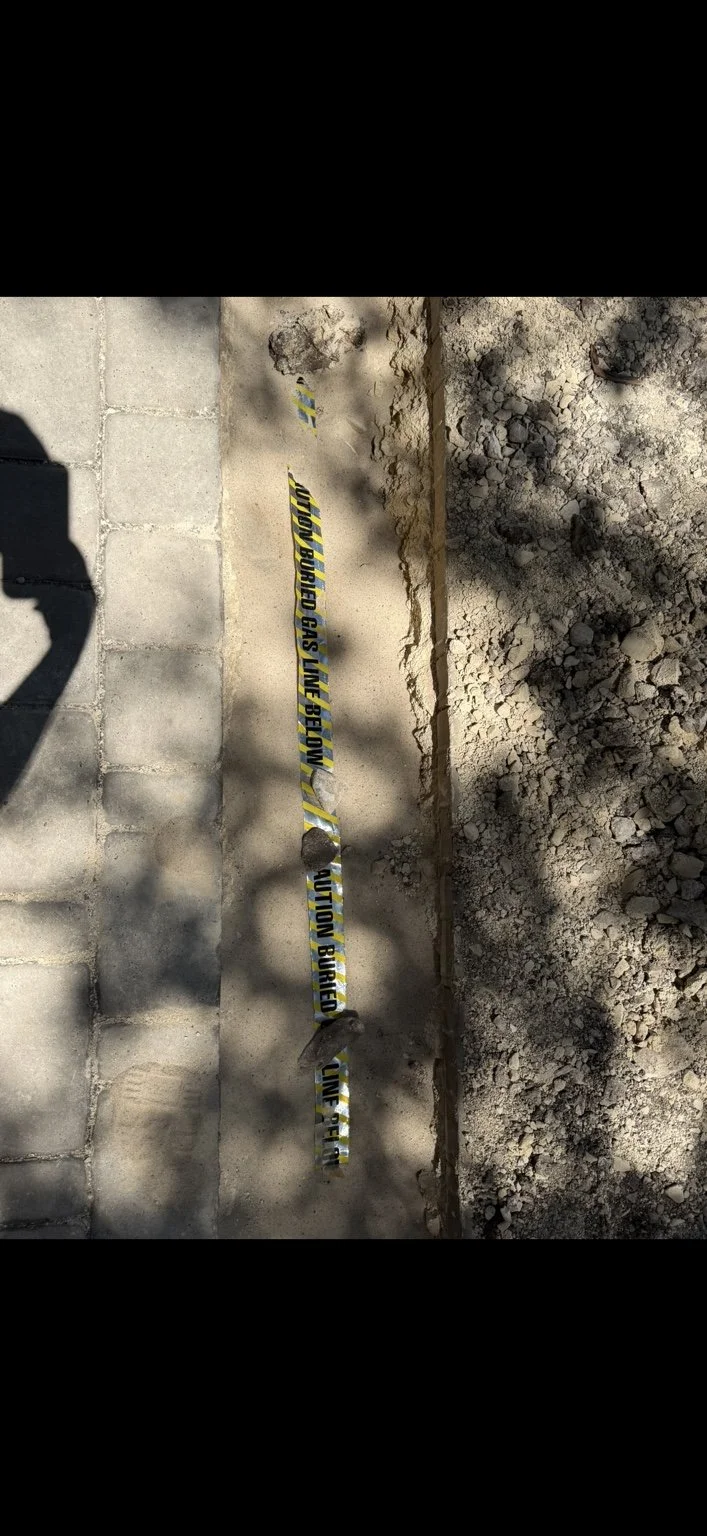Underground gas-line trench and warning tape installed by A2 Plumbing in San Antonio