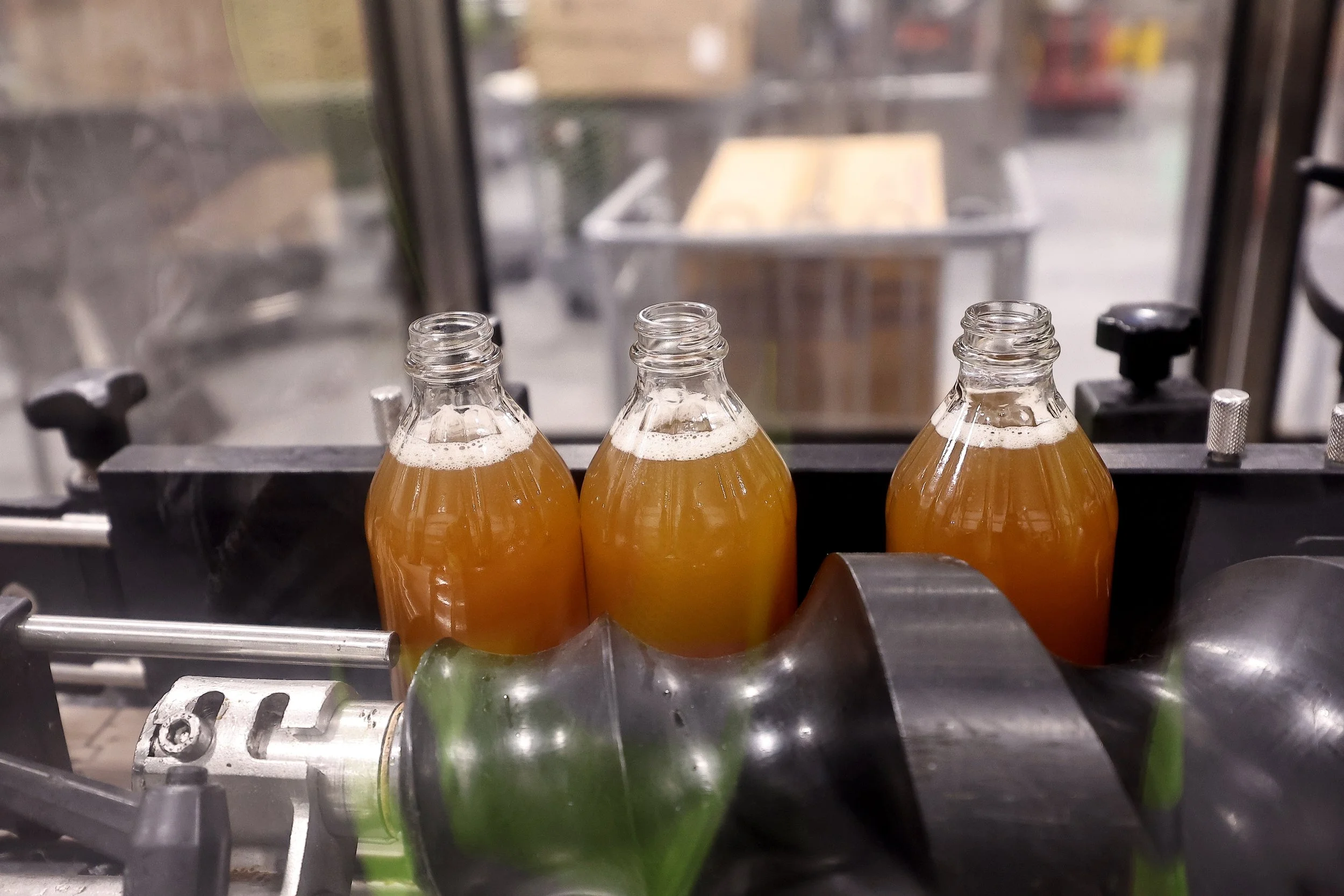 Bottles of Apple Cider Vinegar being Filled