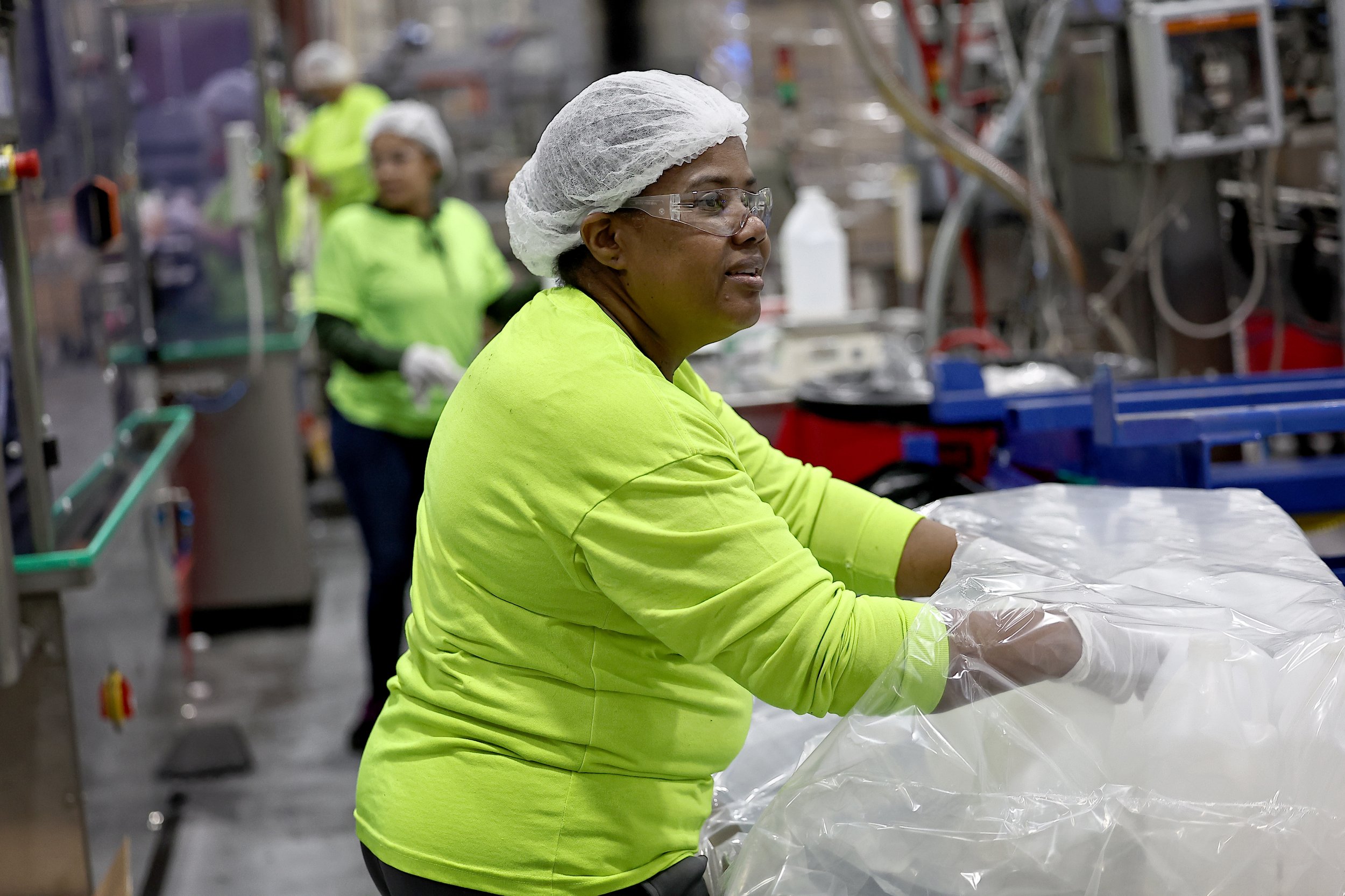 Female Employee Unloading Bottles