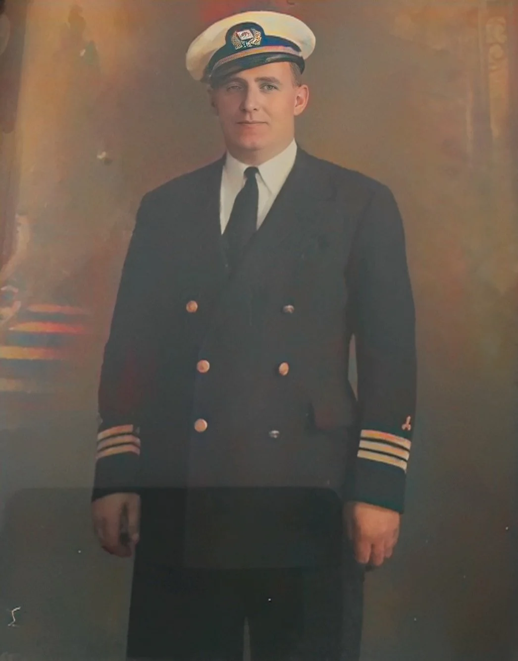 Photo of Relative in a U.S. Merchant Navy officer uniform, standing in front of a painted backdrop,
