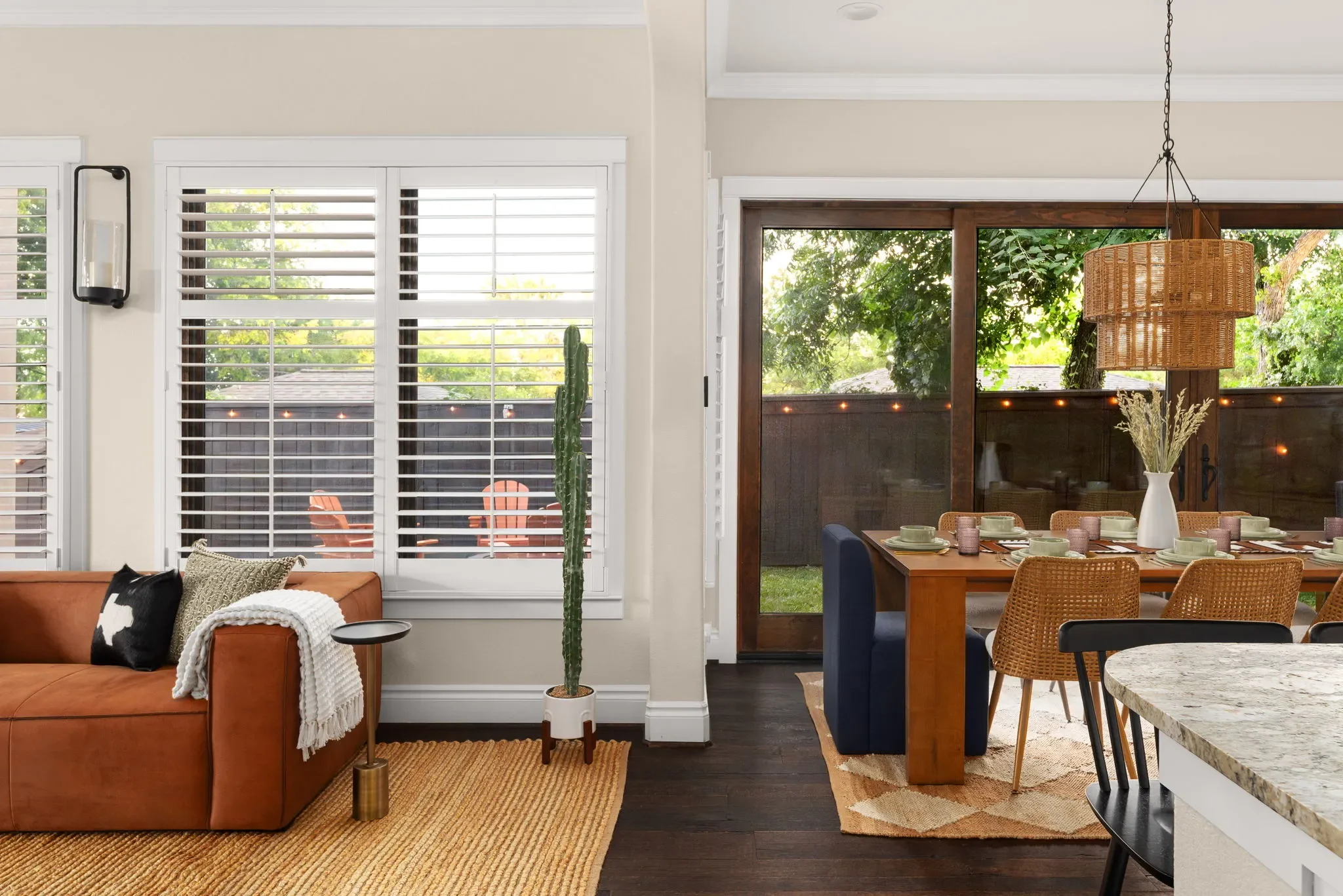 Open living and dining area featuring natural materials, modern western decor, and a leather sofa in a short-term rental home in Austin, Texas.