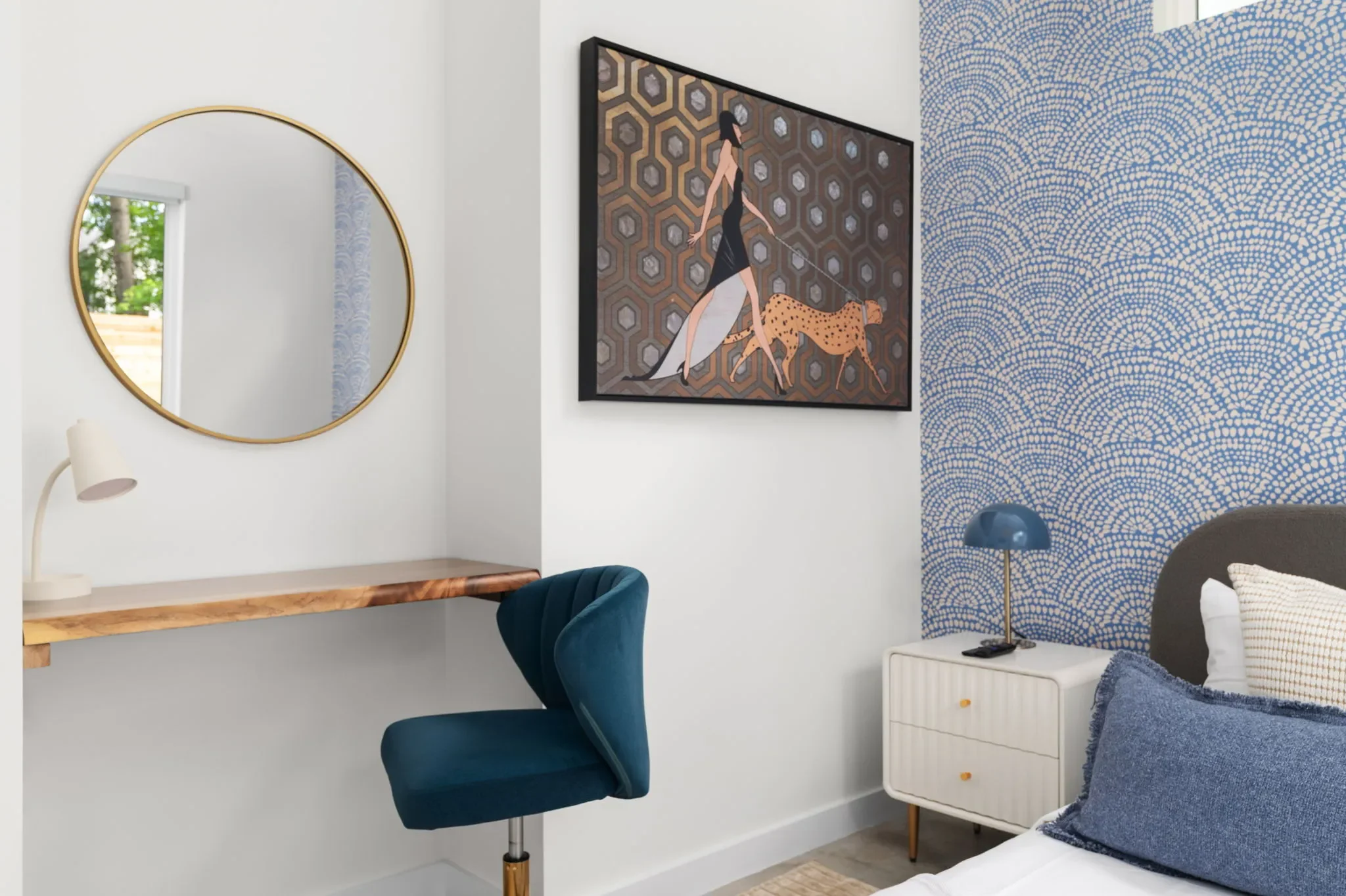 Modern bedroom with blue patterned wallpaper, built-in desk area with teal office chair, and leopard woman wall art.