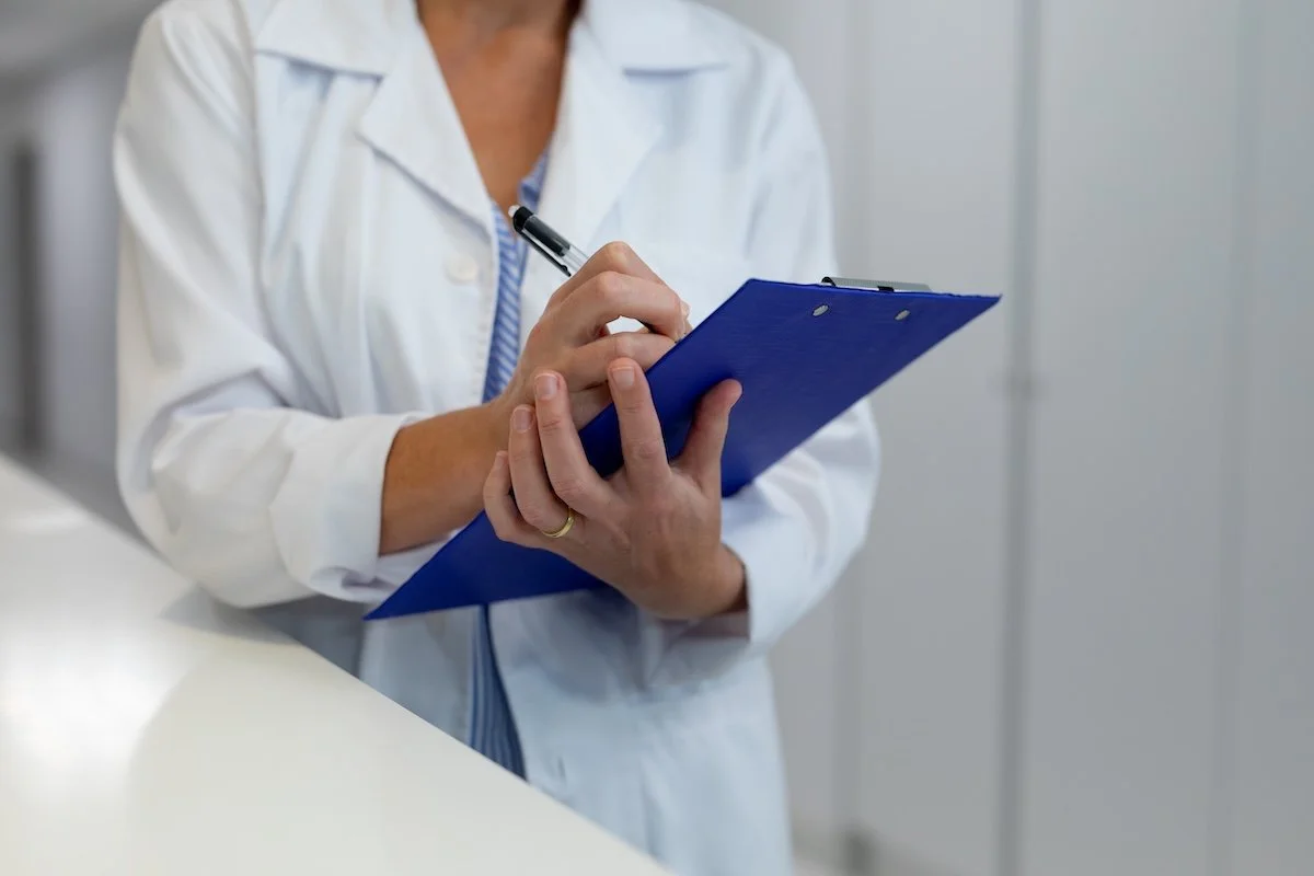 A female doctor holding a clipboard.