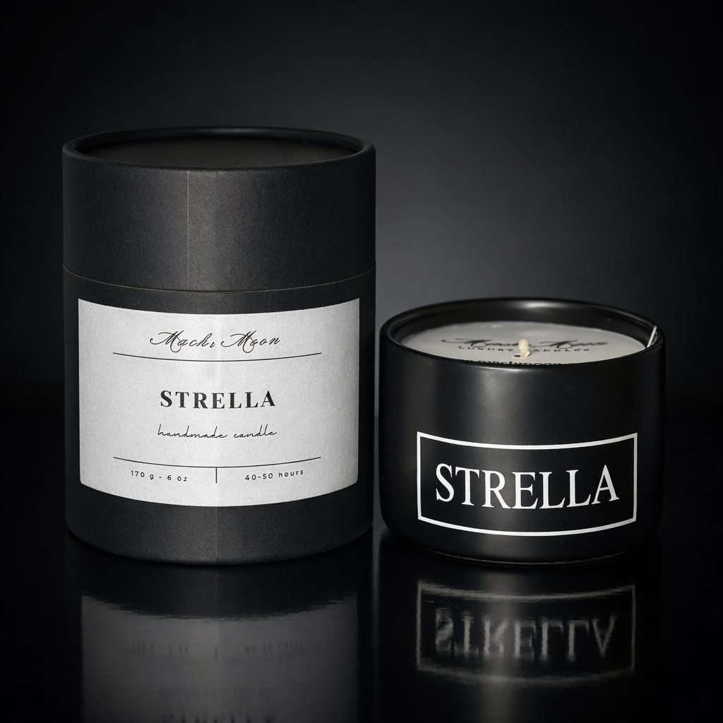 A black cylindrical box and a black glass jar candle with white labels, both labeled "Strella," placed on a reflective black surface against a dark background.