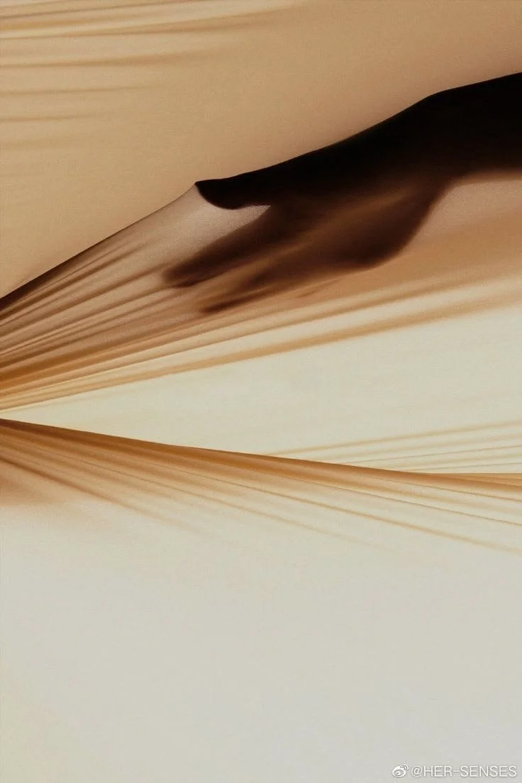 Close-up of a hand turning the pages of a book with beige pages
