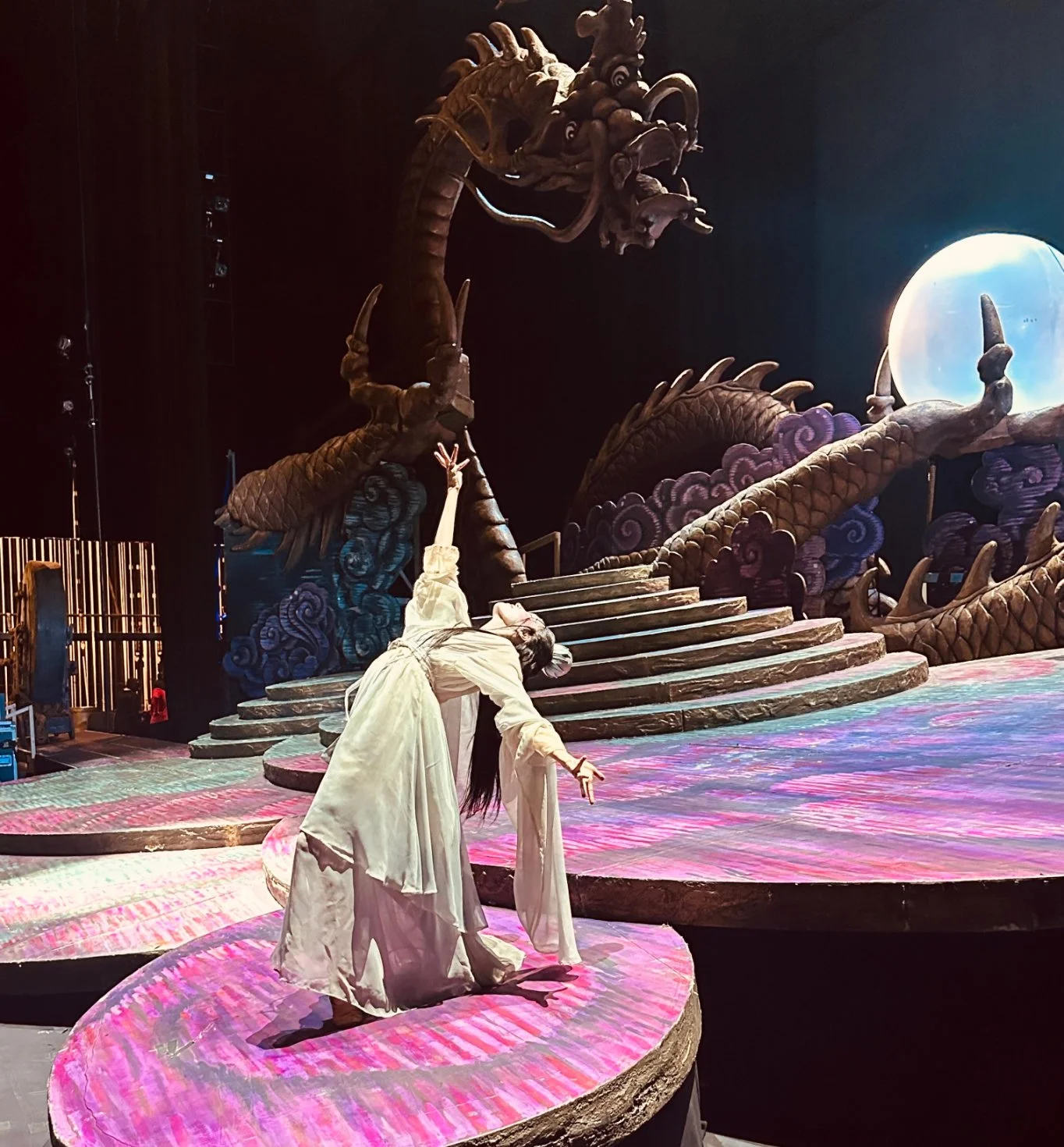 Emily Ricca professional ballet artist performing on theatrical stage with dramatic dragon set design