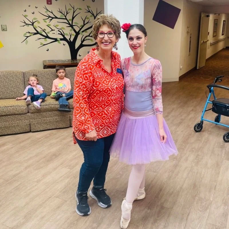Ballet dancer Emily Ricca posing with senior living community resident
