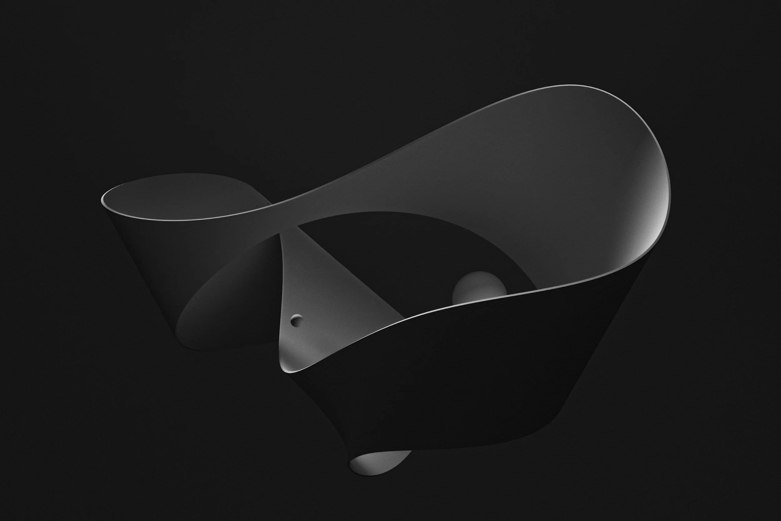 A black and white photograph of an abstract, curved metal sculpture with smooth surfaces and openings, set against a dark background.