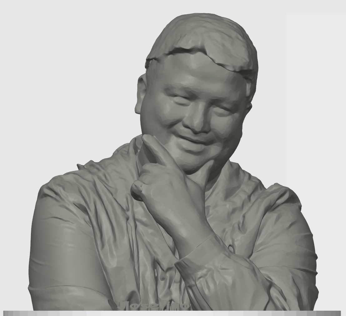 3D grayscale sculpture of a person with short hair, smiling, with one hand on their chin, wearing a jacket.