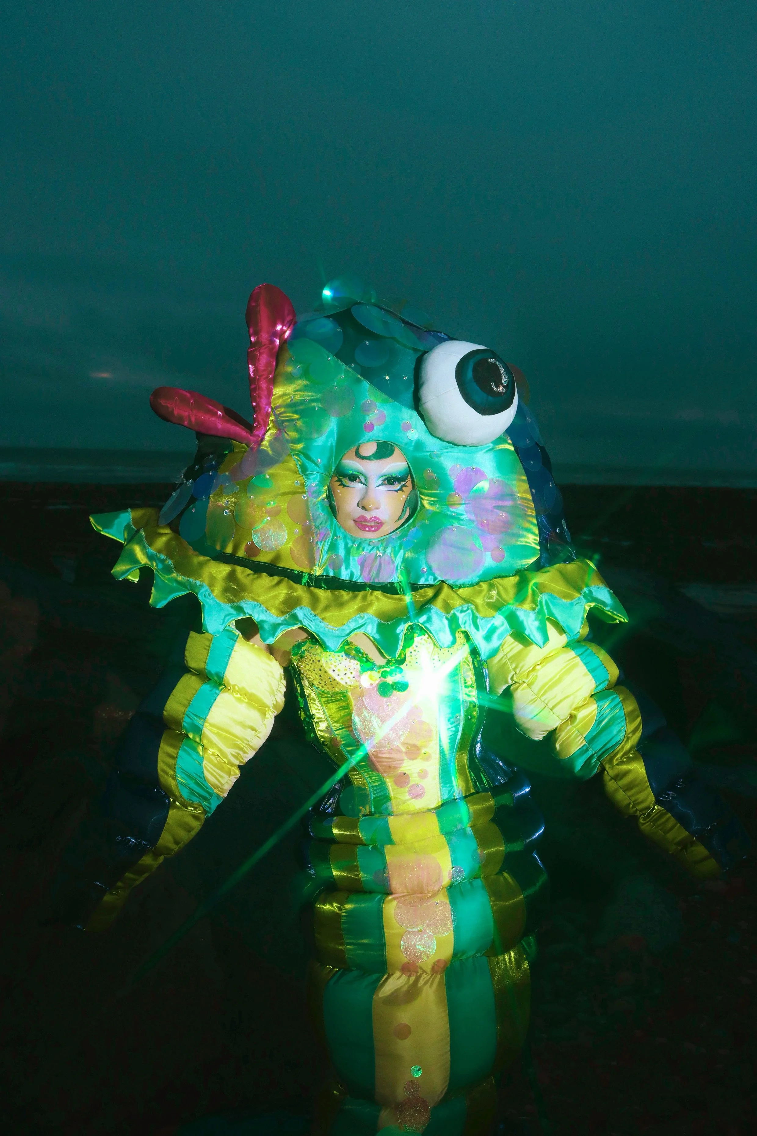 Mocha for Ru Paul’s Drag Race ‘Kitsch’ runway wearing custom big fish ensemble. Shot by Starlet. Assisted by Tayris Mongardi and Inga Rock. Fish inner head caging by Starlet. Sequins by Mocha, Ariana Cherry, Inga Rock, Boudica the Queen and Tayris Mo