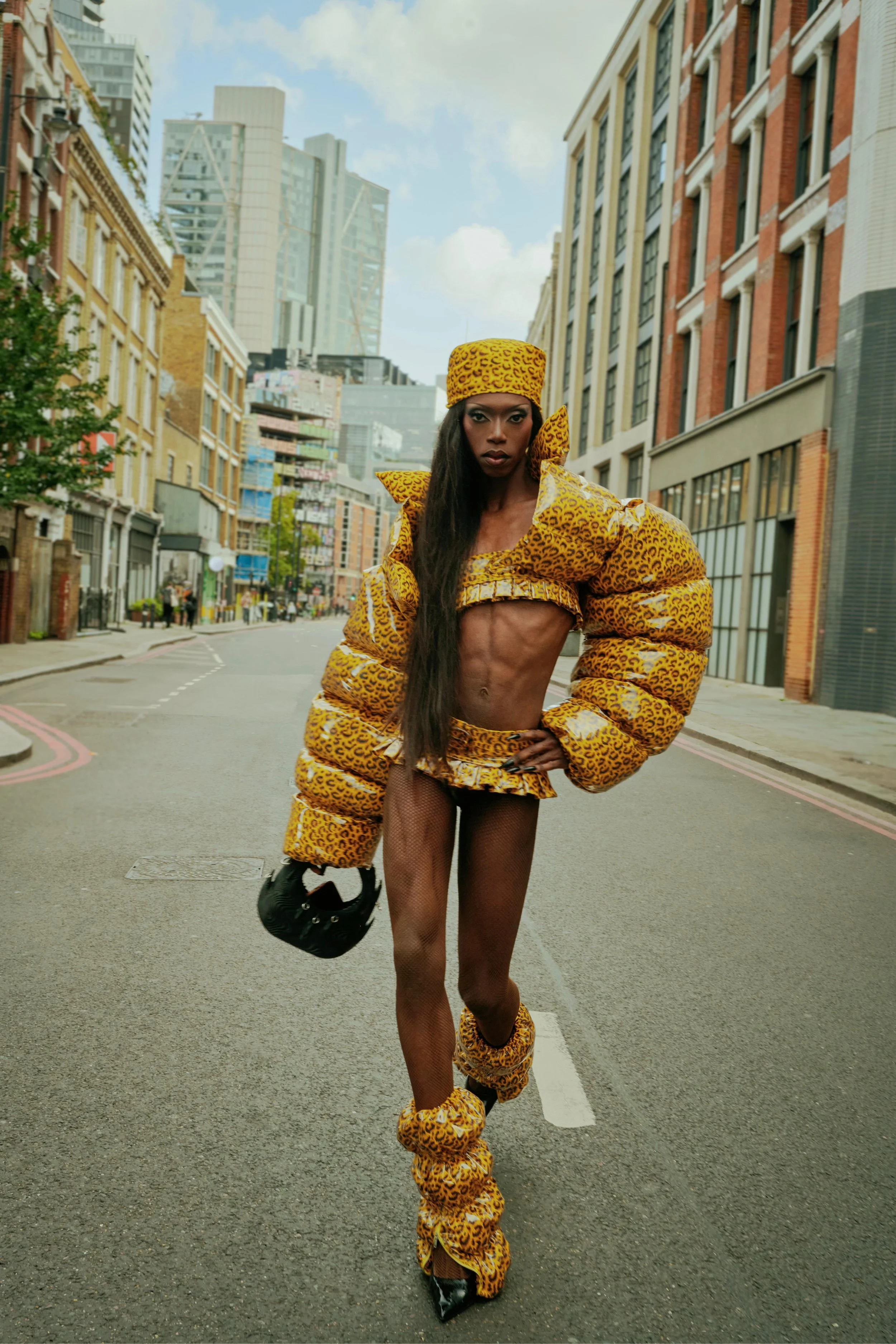 Black Peppa attending London Fashion Week in custom puffer coat and skirt ensemble.
Photos by Kim Lang.