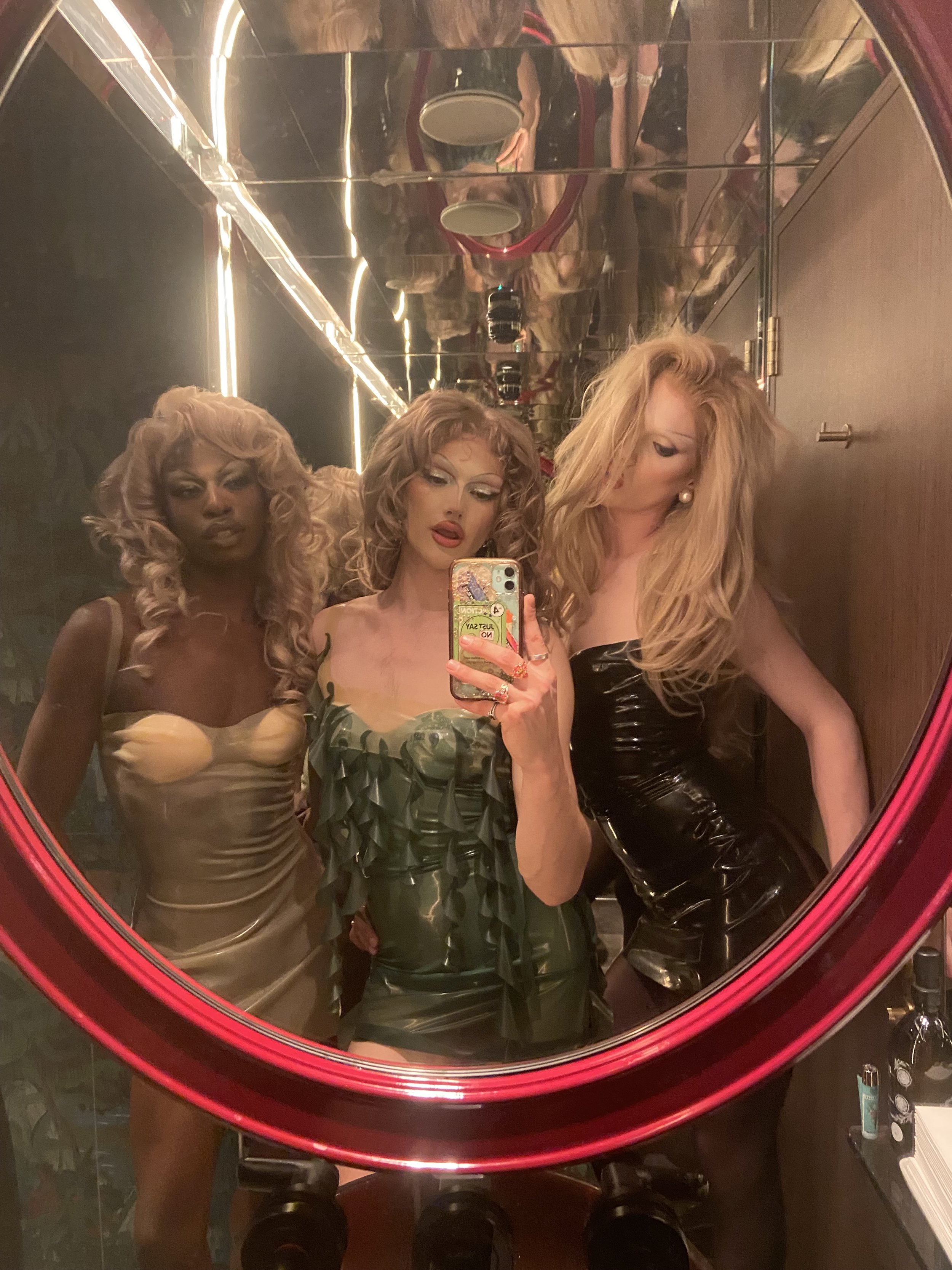 Mode girls all wearing latex Bunni slip dresses at the Housewives of London season 2 drag roast party.