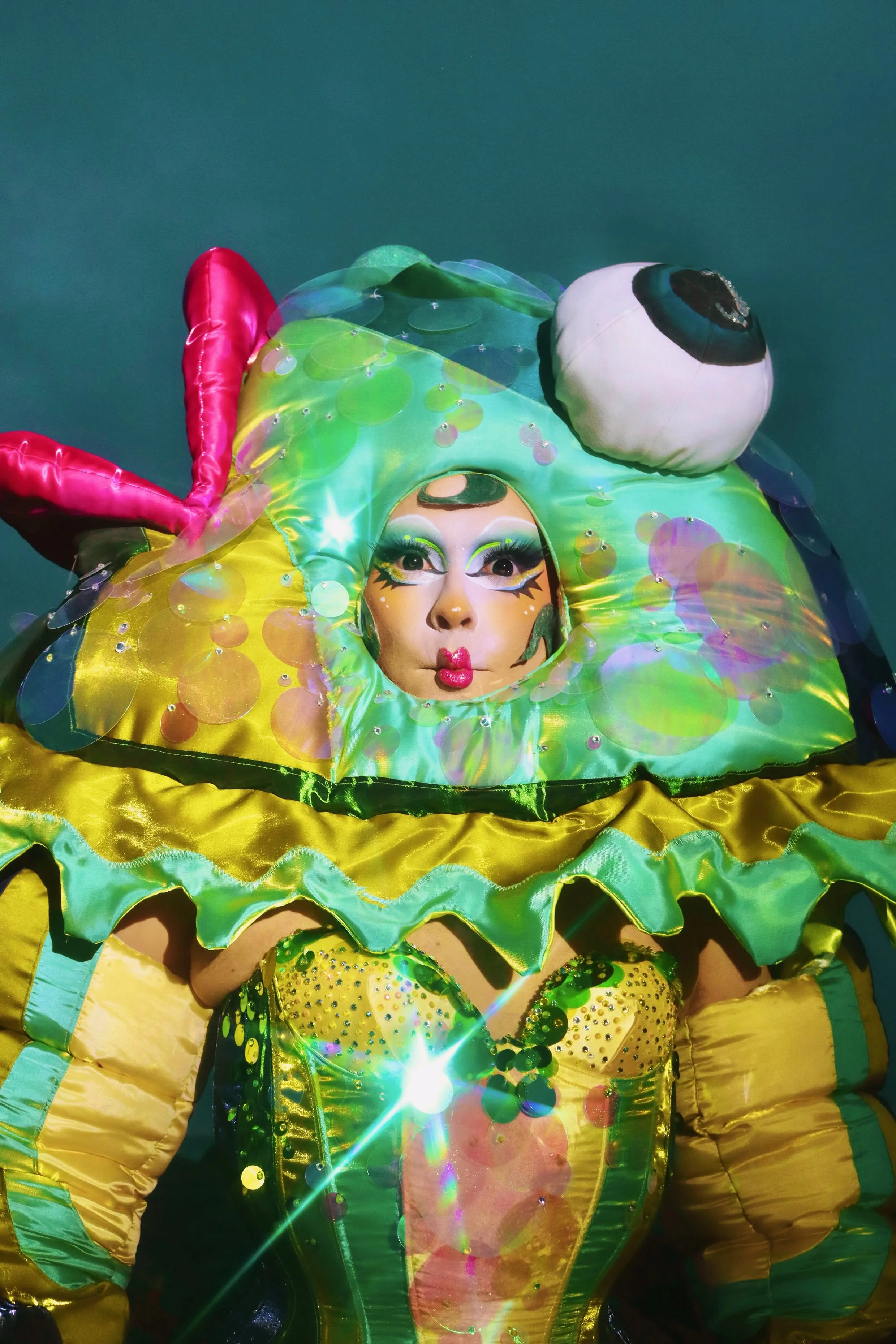 Mocha for Ru Paul’s Drag Race ‘Kitsch’ runway wearing custom big fish ensemble. Shot by Starlet. Assisted by Tayris Mongardi and Inga Rock. Fish inner head caging by Starlet. Sequins by Mocha, Ariana Cherry, Inga Rock, Boudica the Queen and Tayris Mo