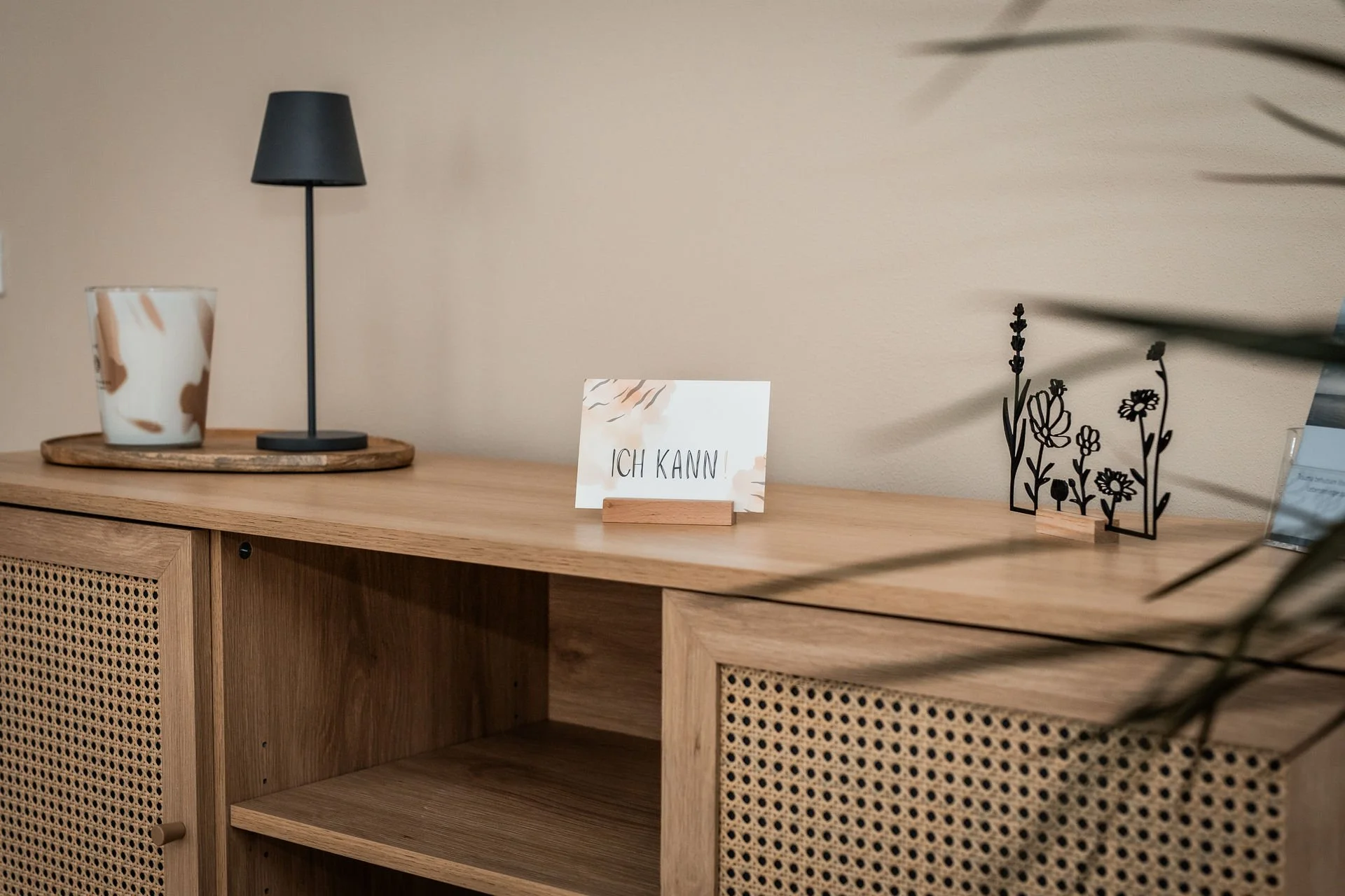 Holzkonsole mit Lampe, Pflanzen und der Karte ‚Ich kann‘ – symbolische Darstellung von Ressourcenstärkung und Selbstwirksamkeit im Coaching. Saarland