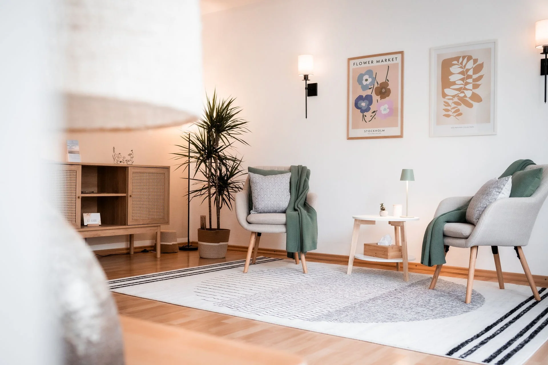 Ruhiger Coachingraum mit zwei Sesseln, Pflanzen und warmem Licht – ein sicherer, einladender Setting für Selbstregulation, Ressourcenarbeit und therapeutisch orientiertes Coaching.