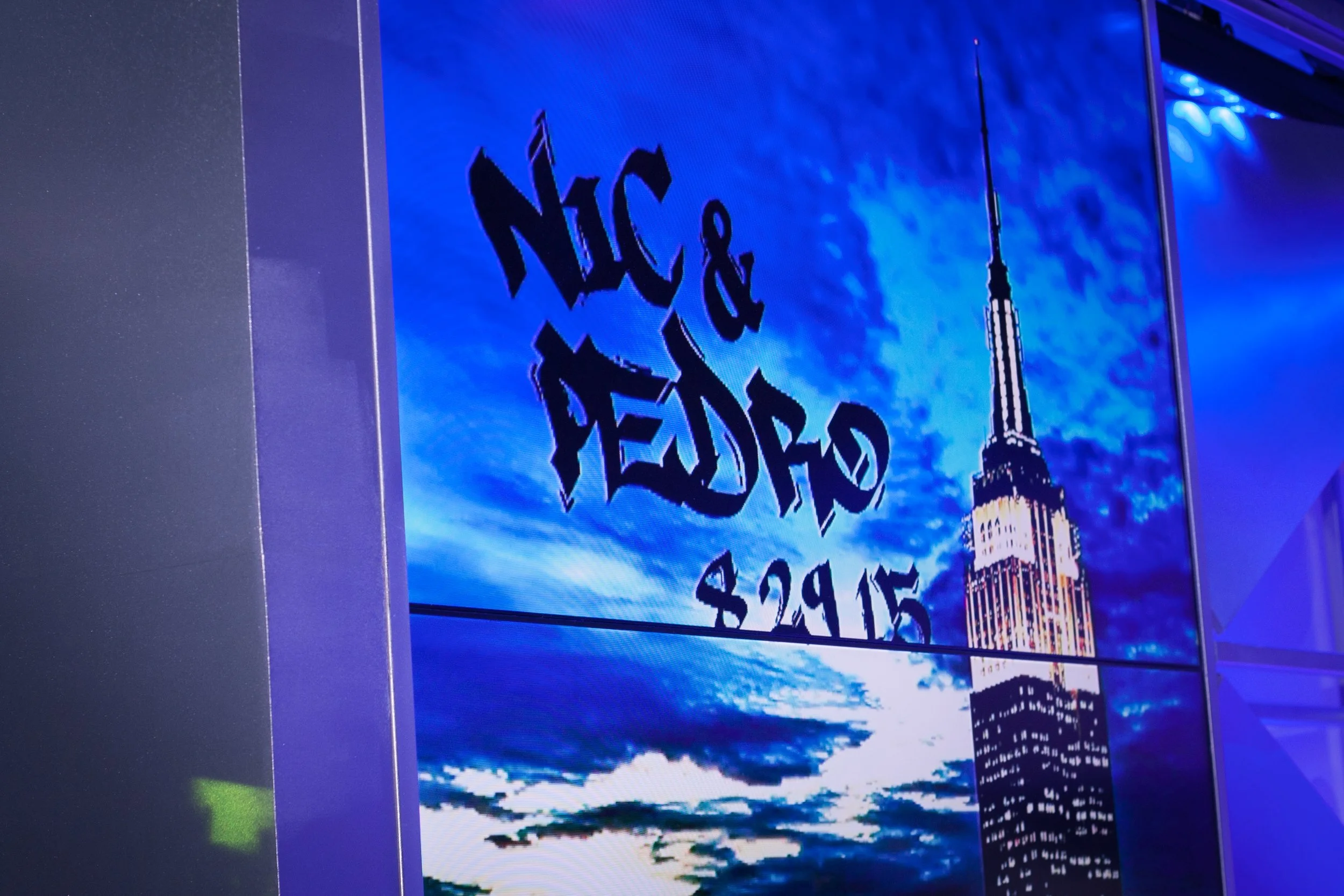The screens shows a video loop of the empire state building, which had been color toned to only show blue and white highlights, tying the screens to the color palette from the physical prints. 