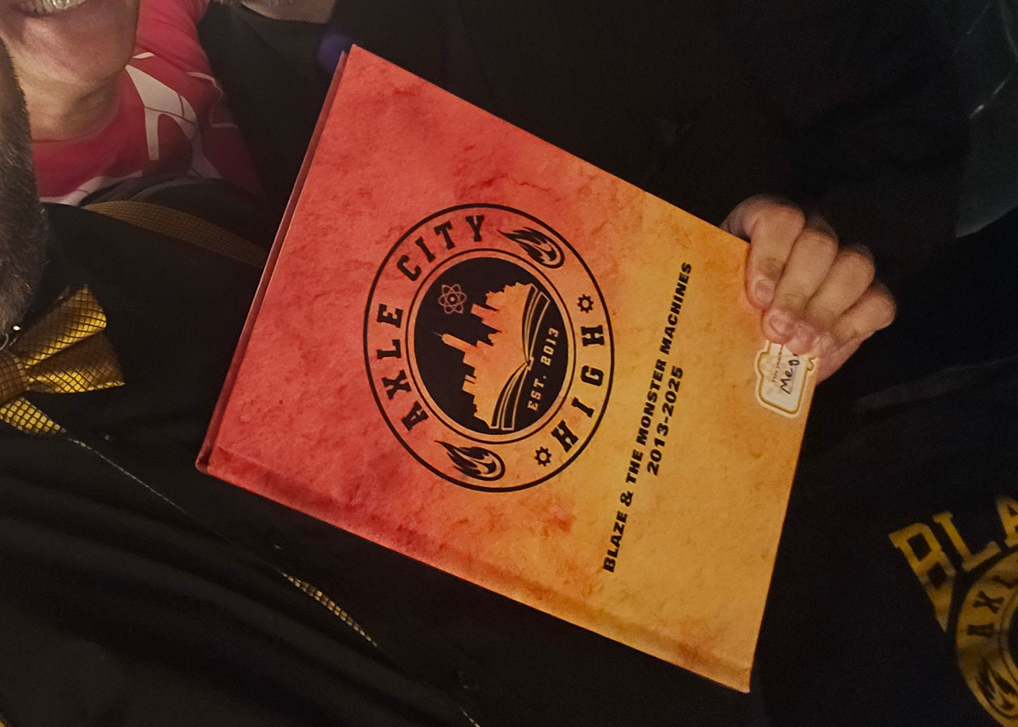 The yearbook, which kept the logo to match the event, but remained in red, orange, and yellow to match the original color of the logo. 
