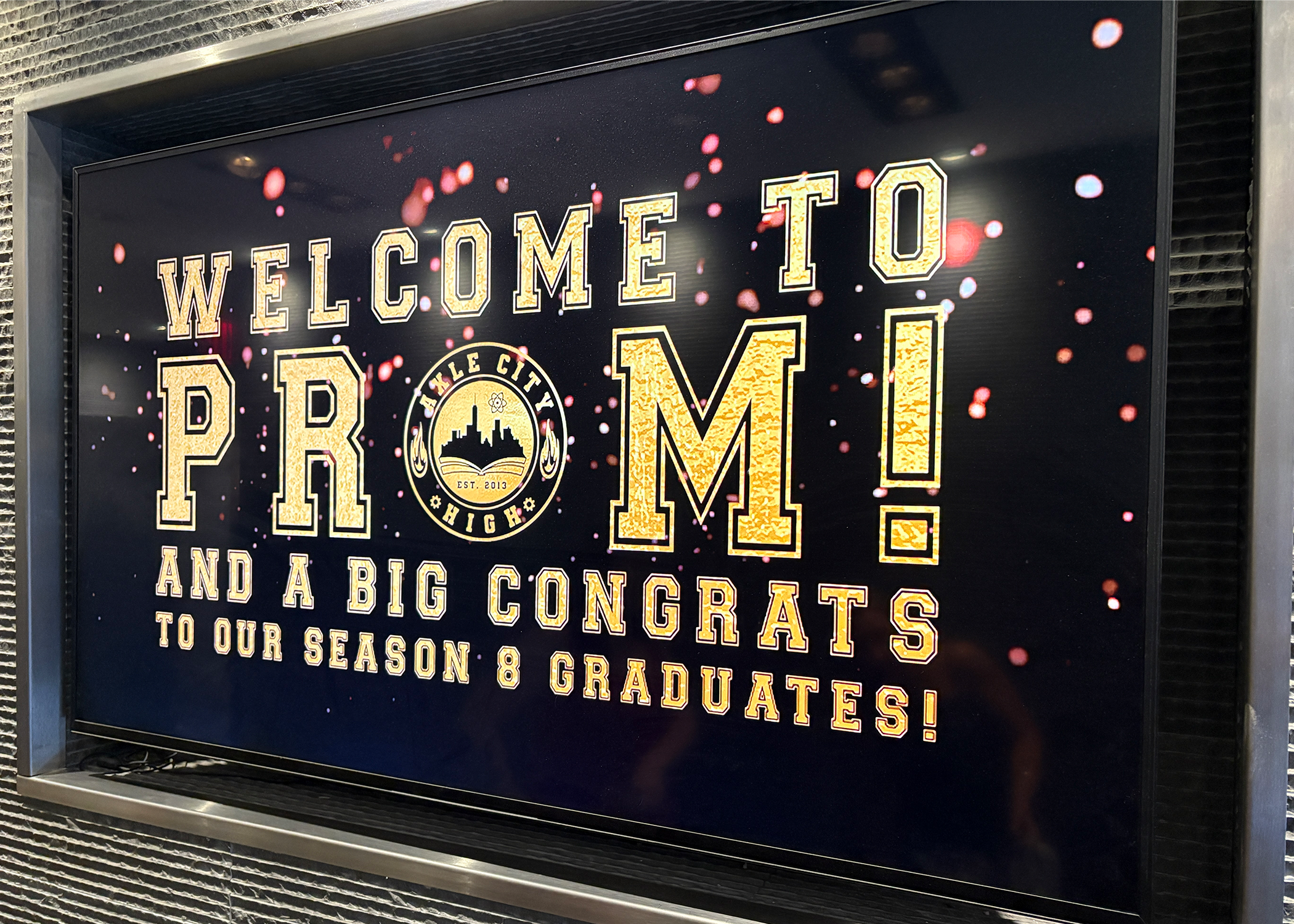 As people entered the building, the screens had college font lettering and gold plating to introduce them to the Prom!