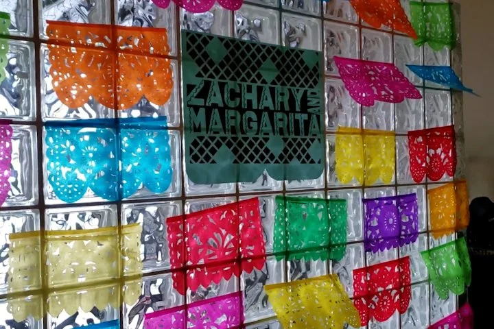 The custom picado surrounded by paper picados created a nice backdrop for the photobooth area. 