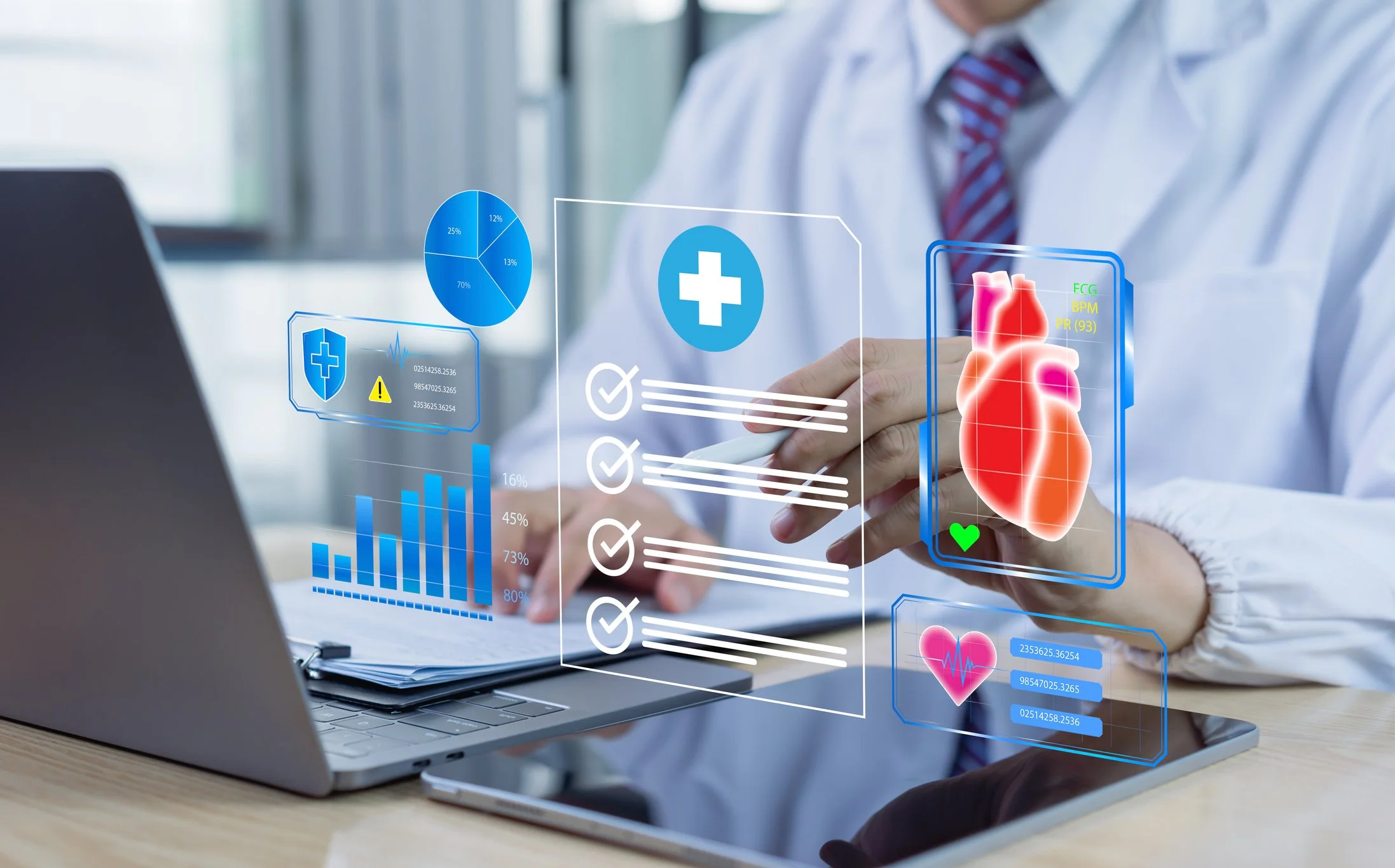 A doctor in a white coat using a stylus with digital medical data and heart health graphics projected in front of him, on a laptop in an office setting.
