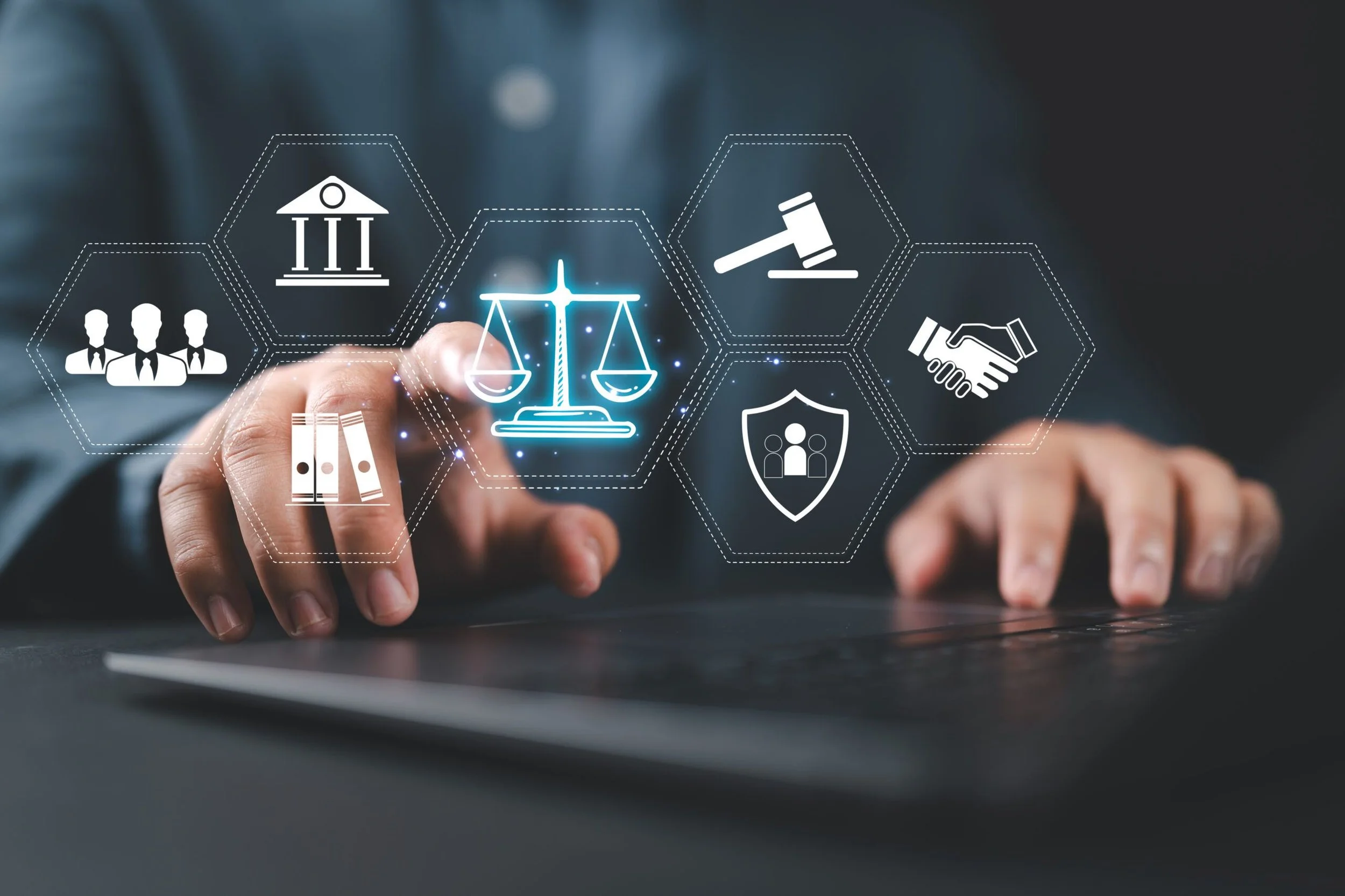 Person with hand extended over a laptop surface, interacting with digital icons representing law, justice, legal services, and court symbols.