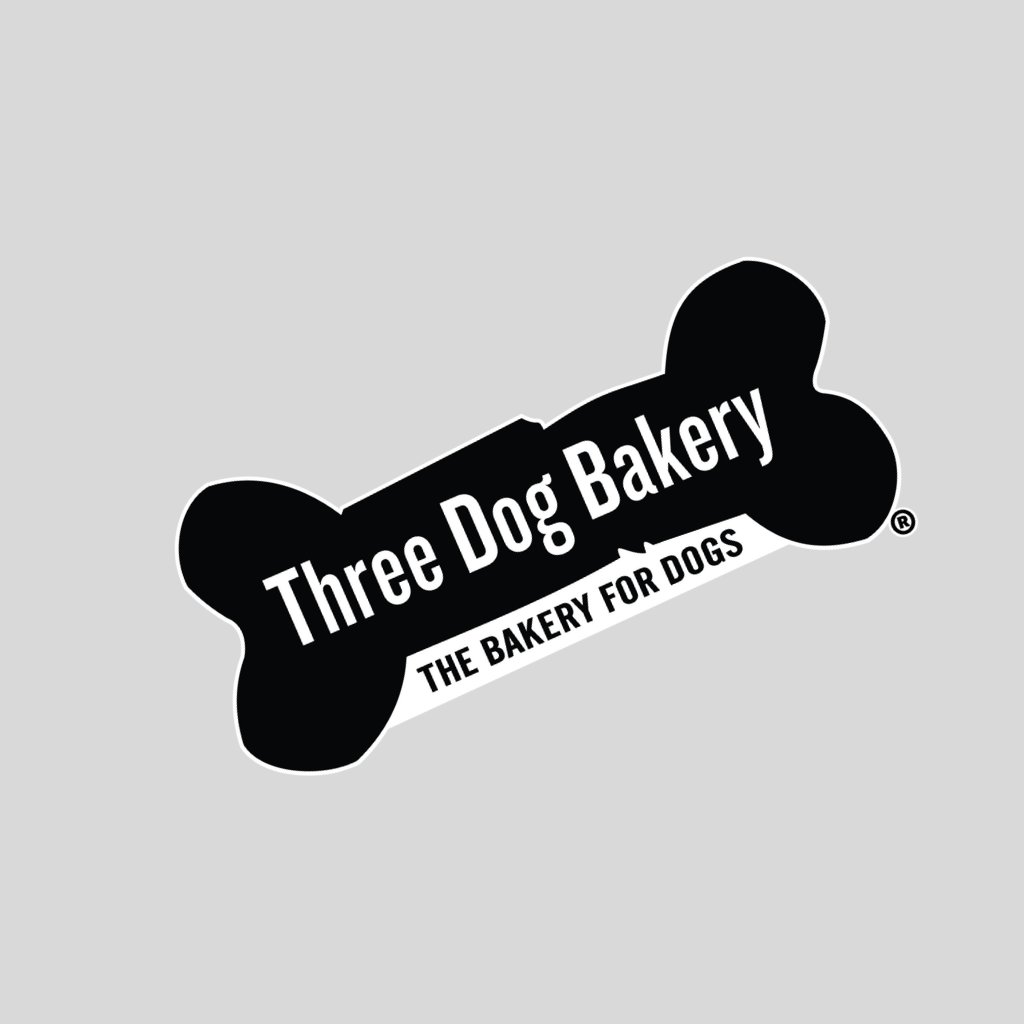 Black and white logo with a dog bone shape, reading "Three Dog Bakery" and "The Bakery for Dogs".