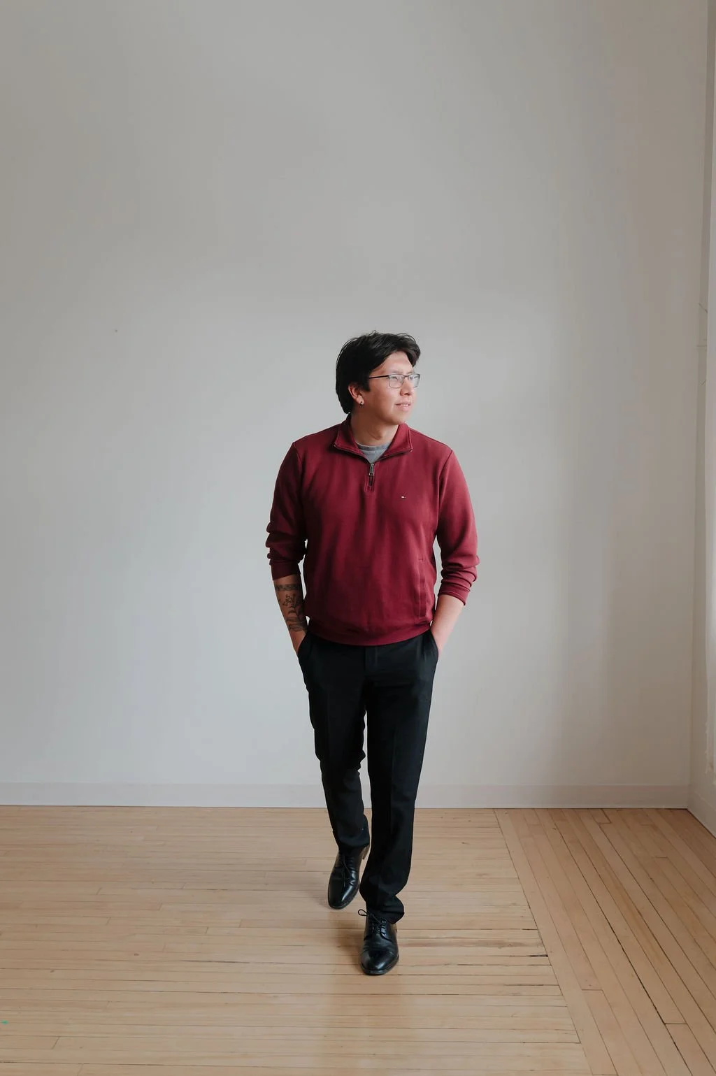 man wearing burgundy sweater, walking.