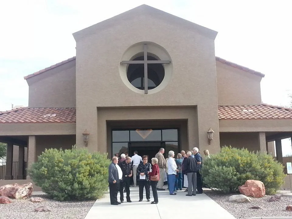 Members at King of Kings Lutheran Church mingling in front of the church building