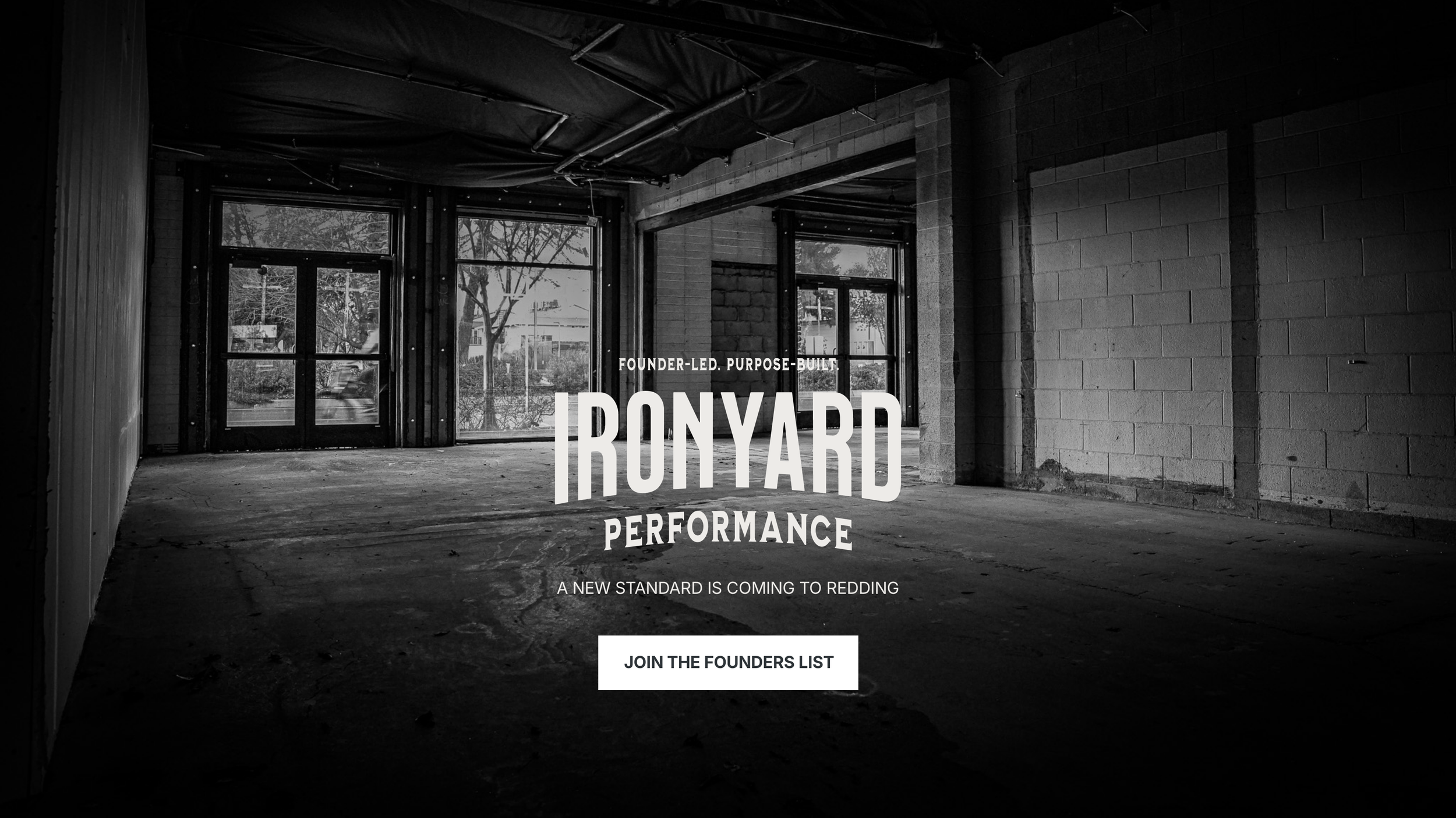 Black and white photo of an empty, unfinished commercial space with large windows and an exposed ceiling, promotional text overlay about 'Ironyard Performance' and a call to action to join the founders' list.