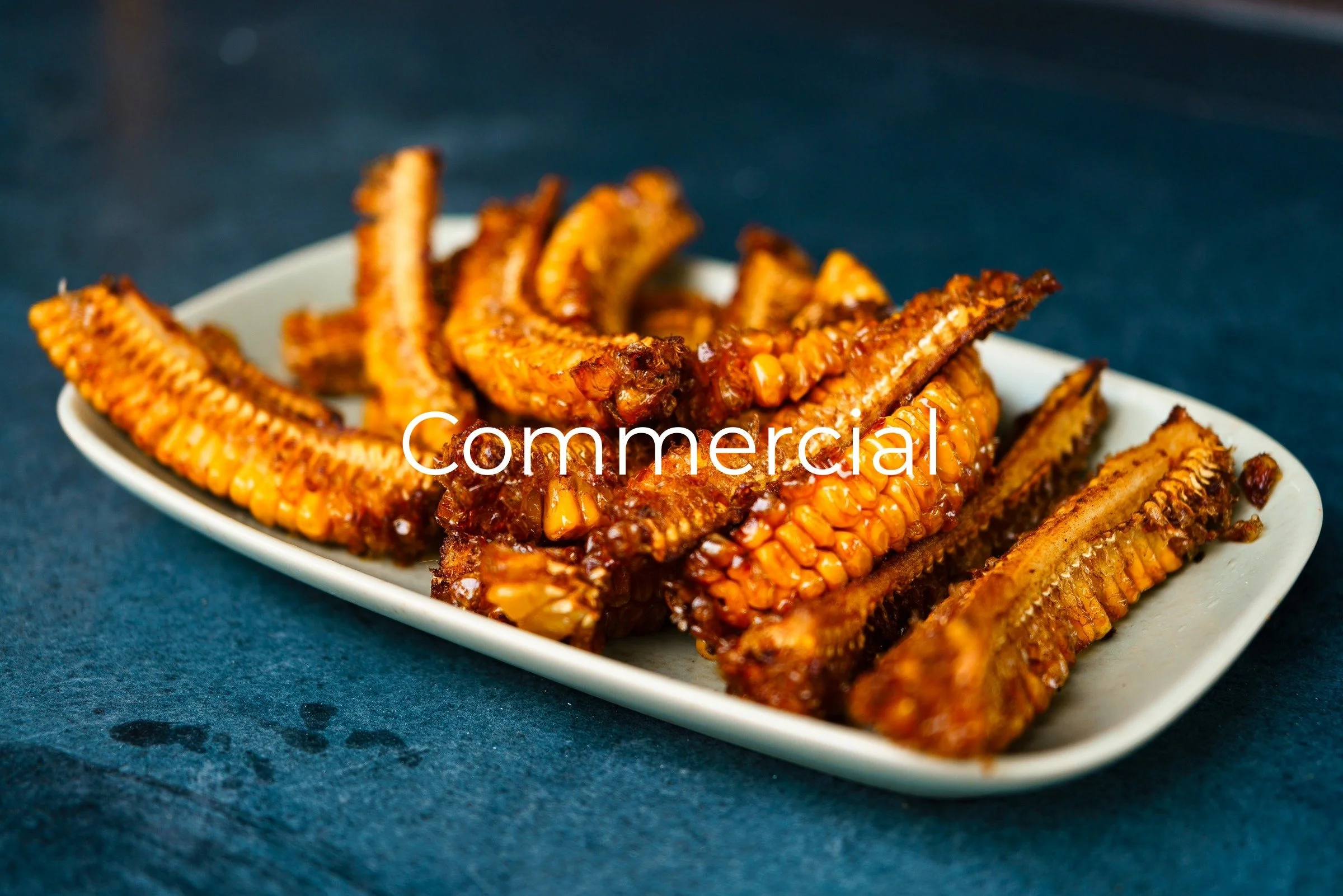 Fried corn stacked on a white rectangular plate