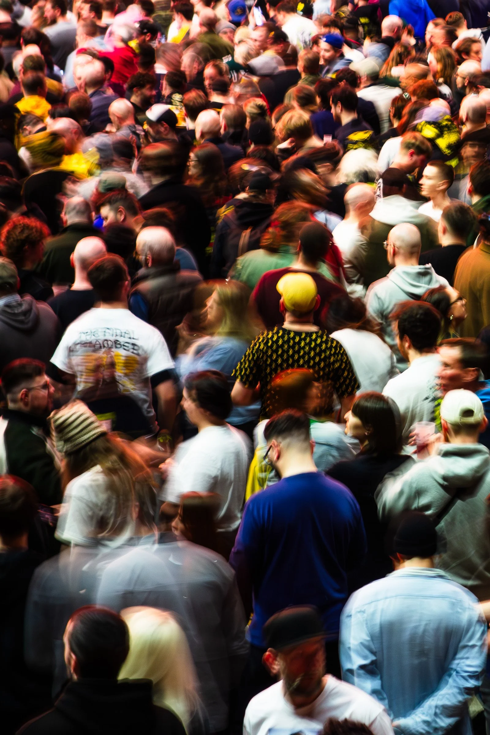 Crowded group of diverse people gathered closely together at an event or public gathering.