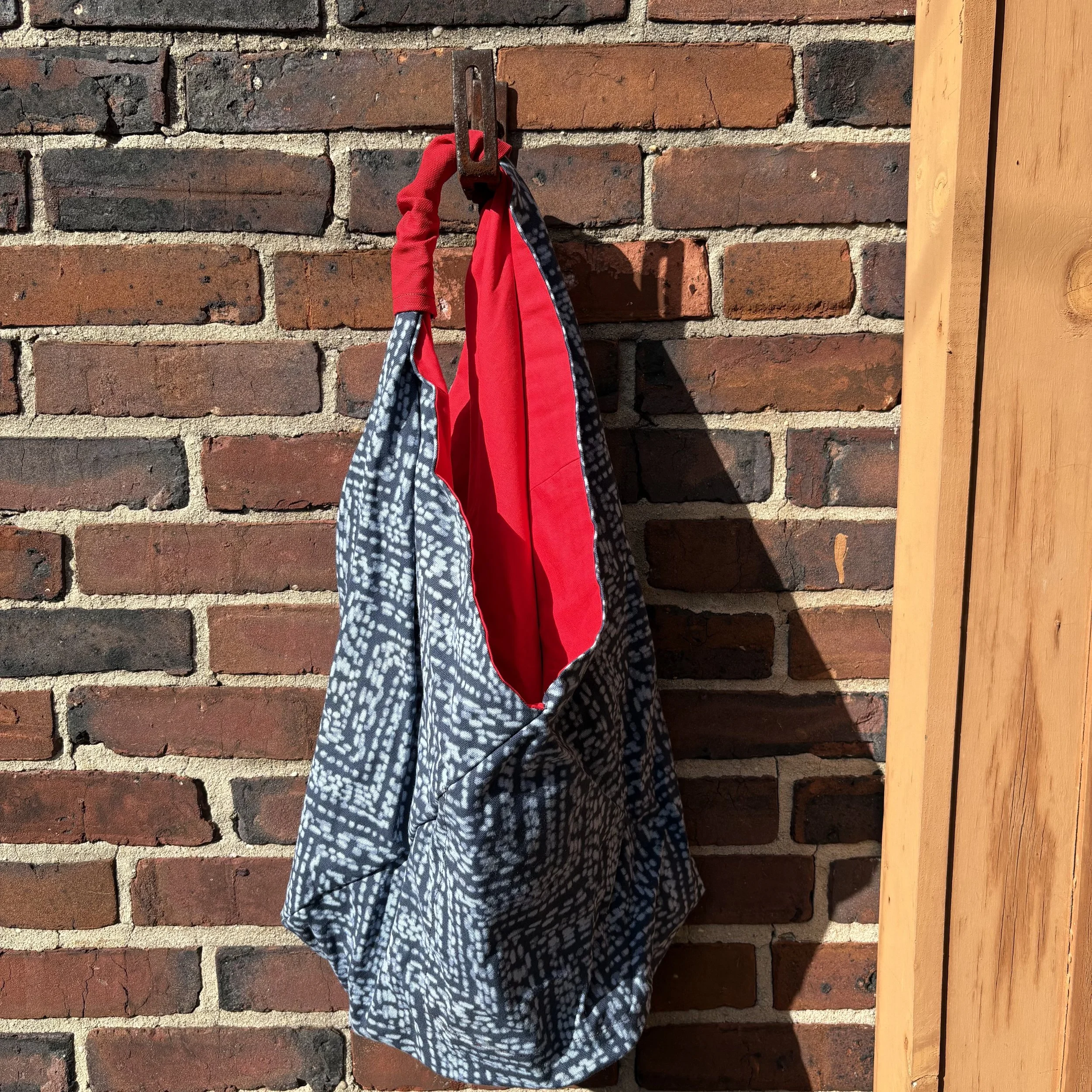 black and white bag with red interior