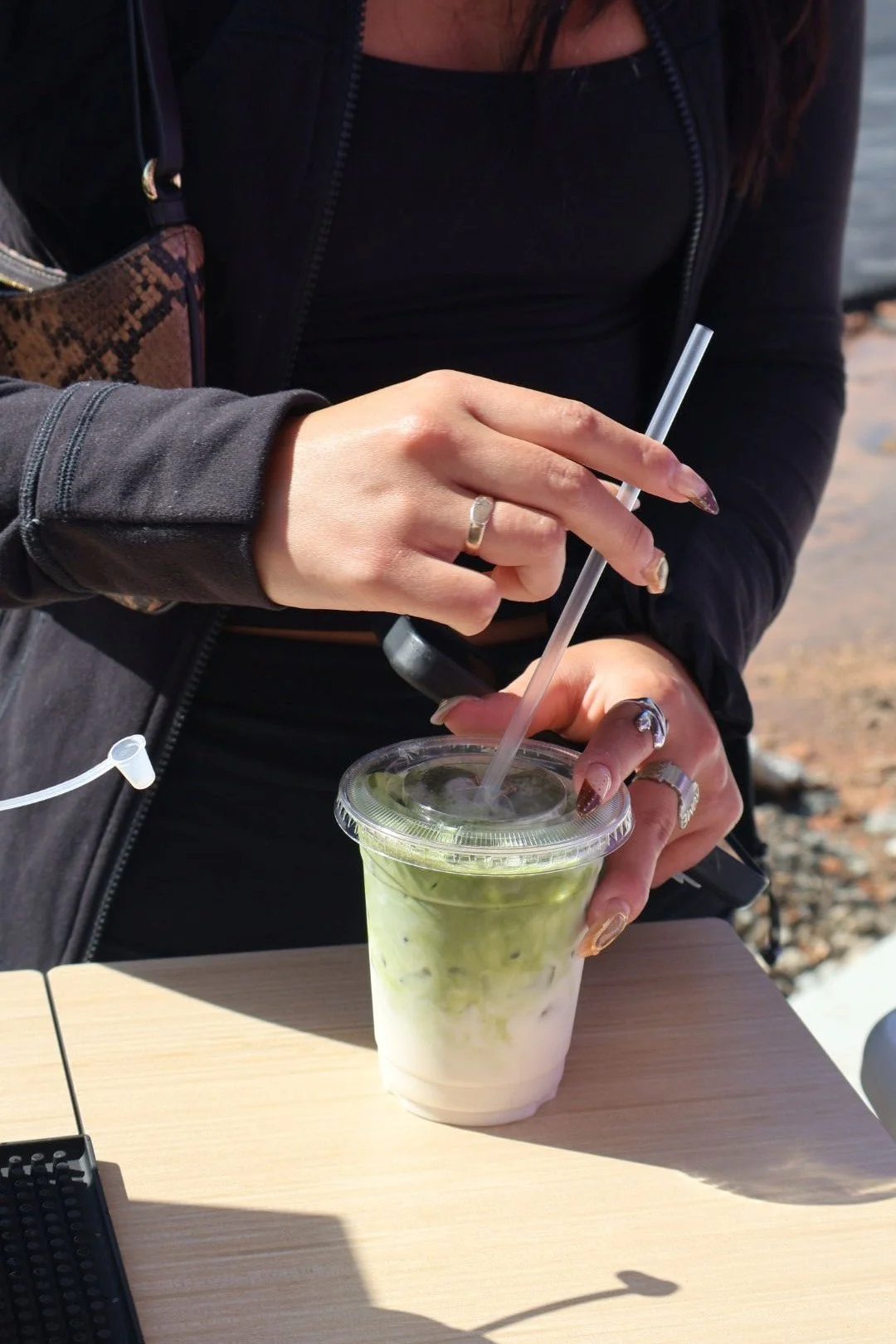 Guest holding lavender iced latte at Atlanta grand opening catering event