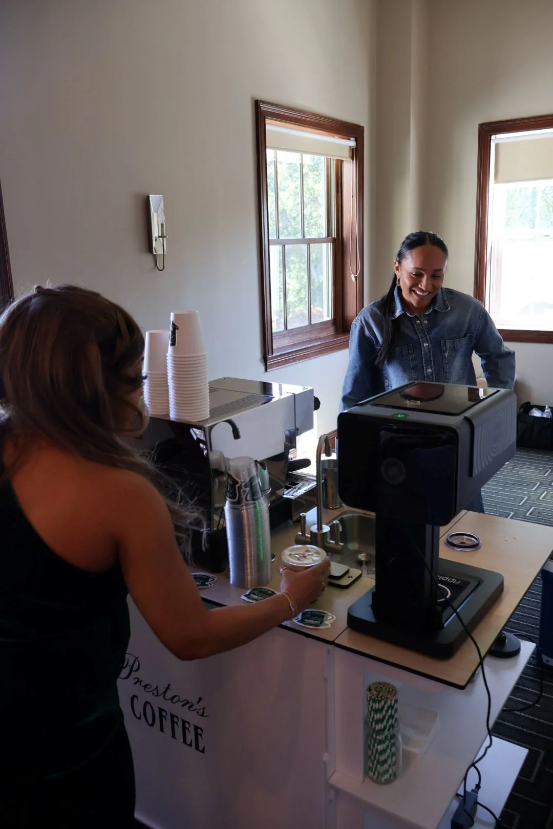 Guest enjoying a freshly prepared latte at an Atlanta baby shower coffee bar